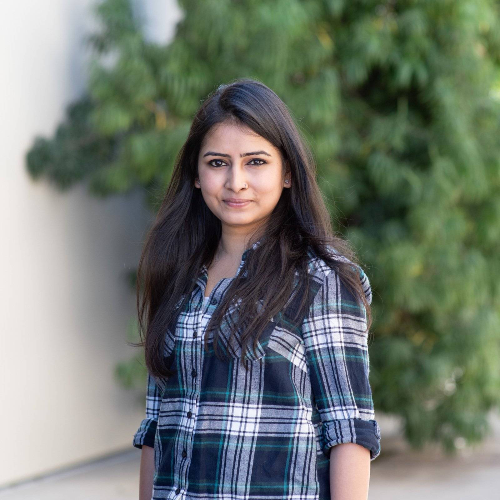 a person standing outside with trees in the background
