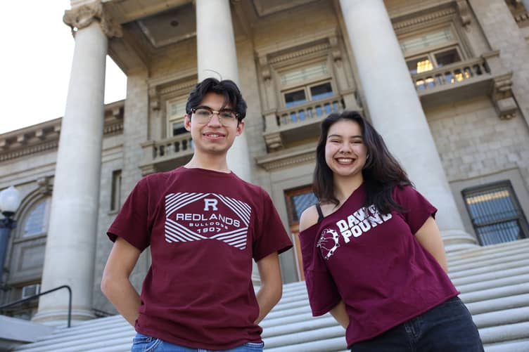 a person and person standing in front of a building