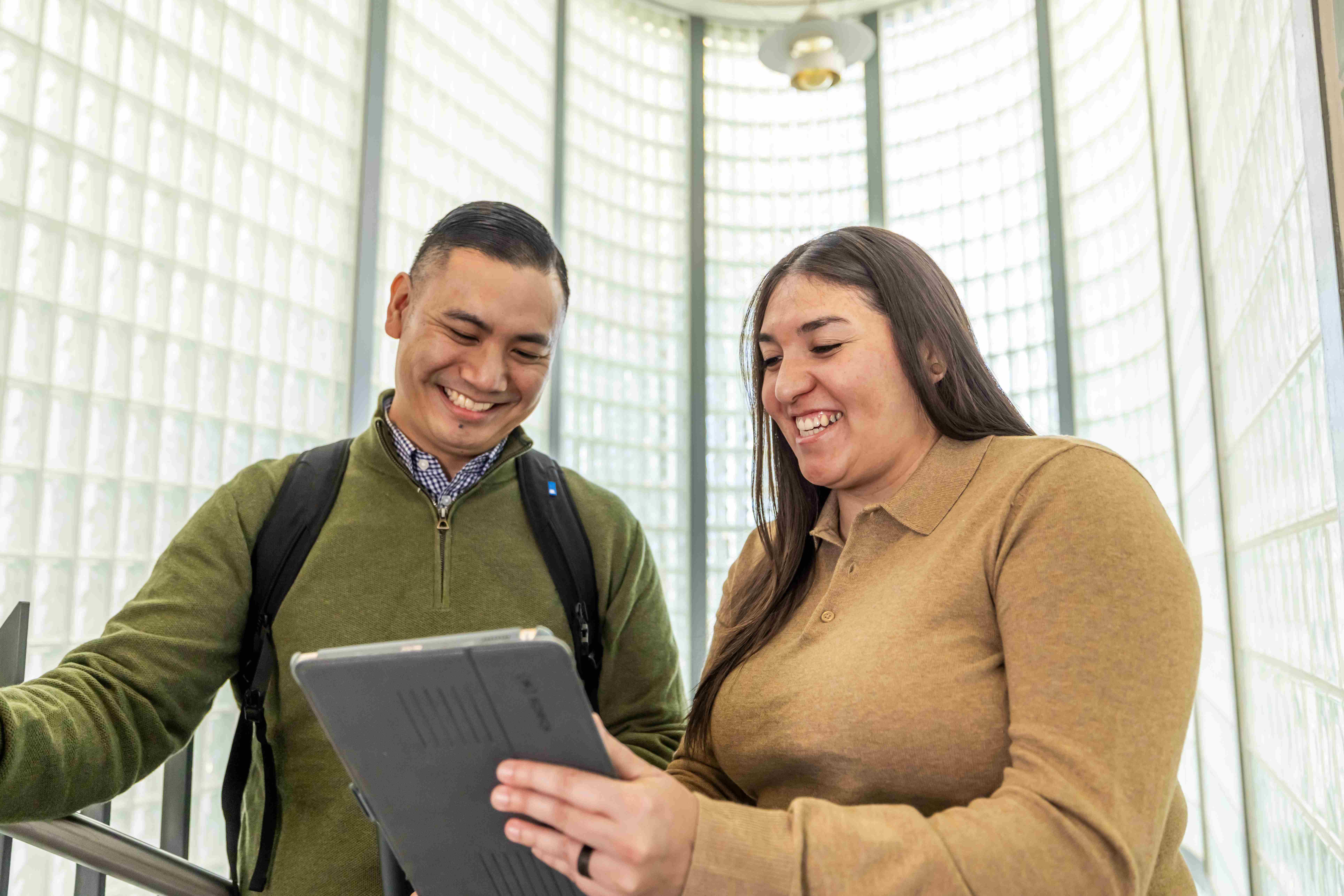 a person and person looking at a tablet