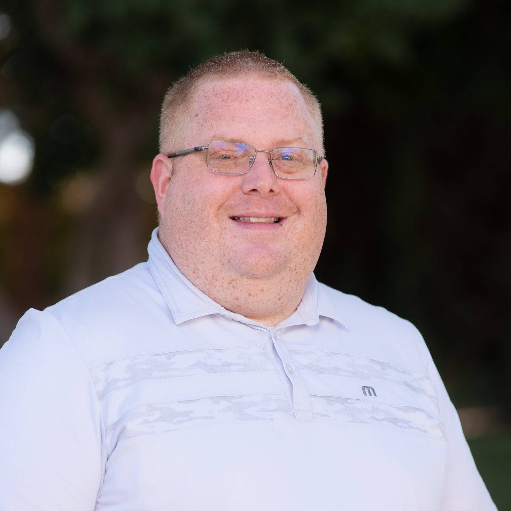 a person wearing glasses and a white shirt