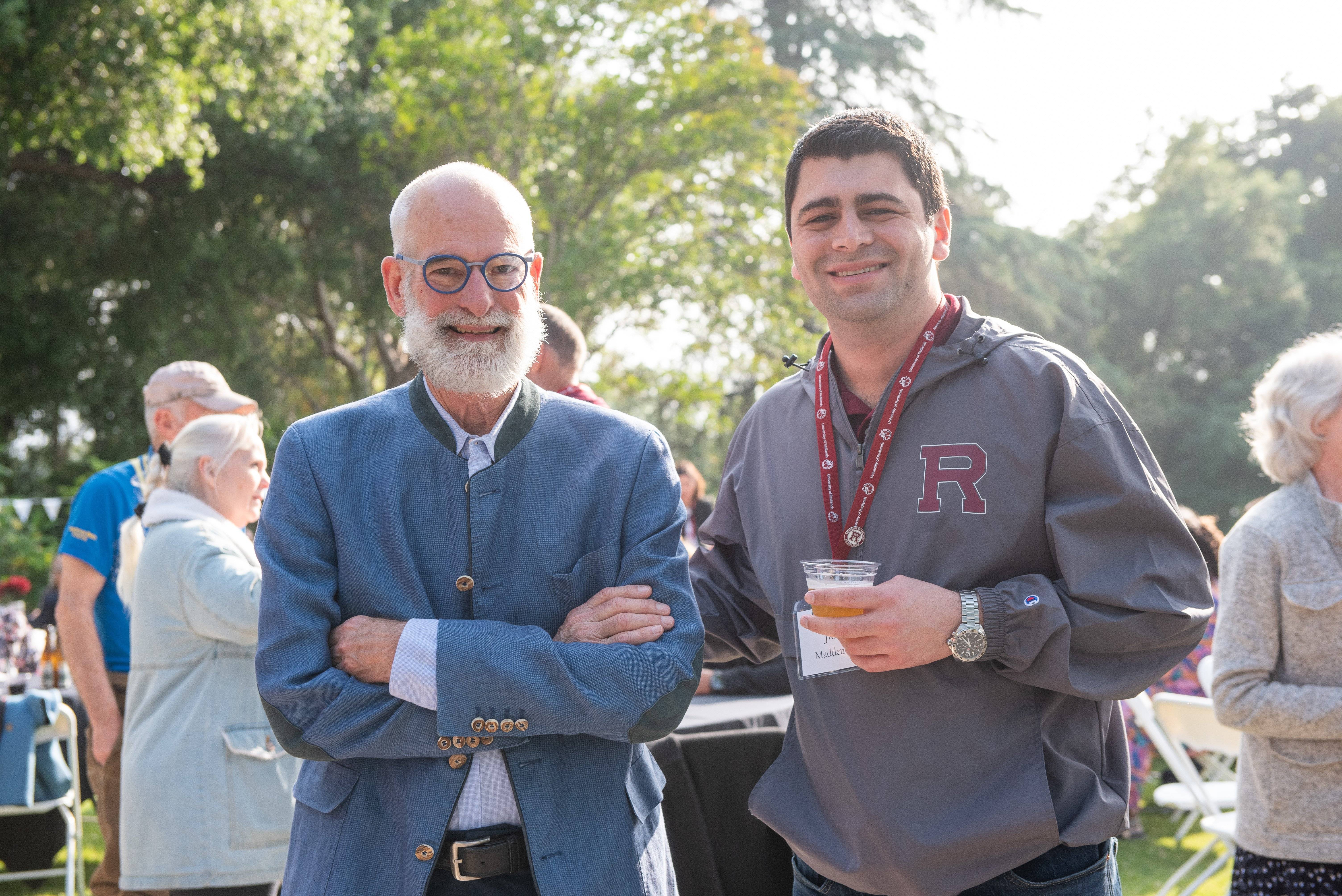 two men standing outside smiling