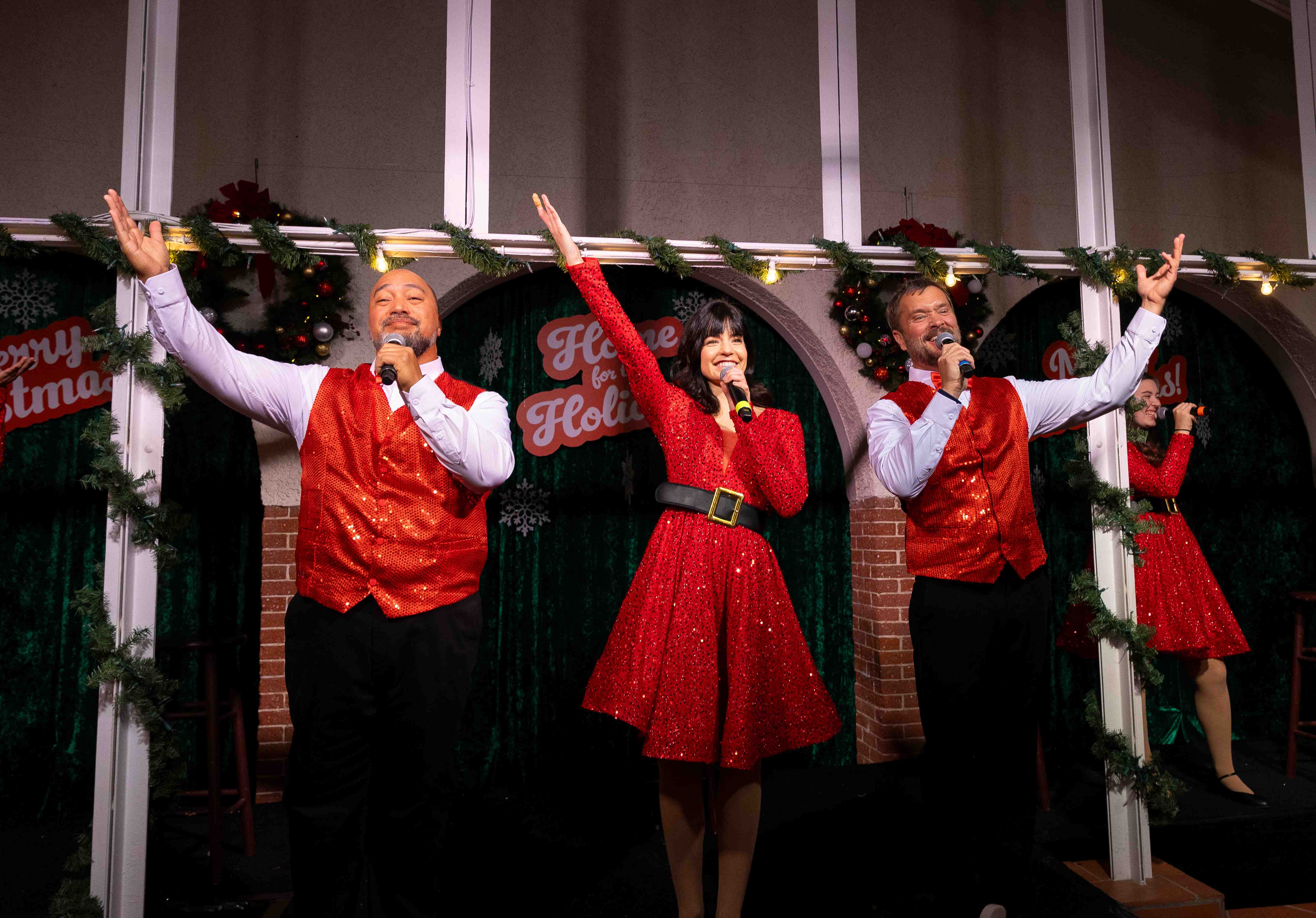 a group of people singing on a stage
