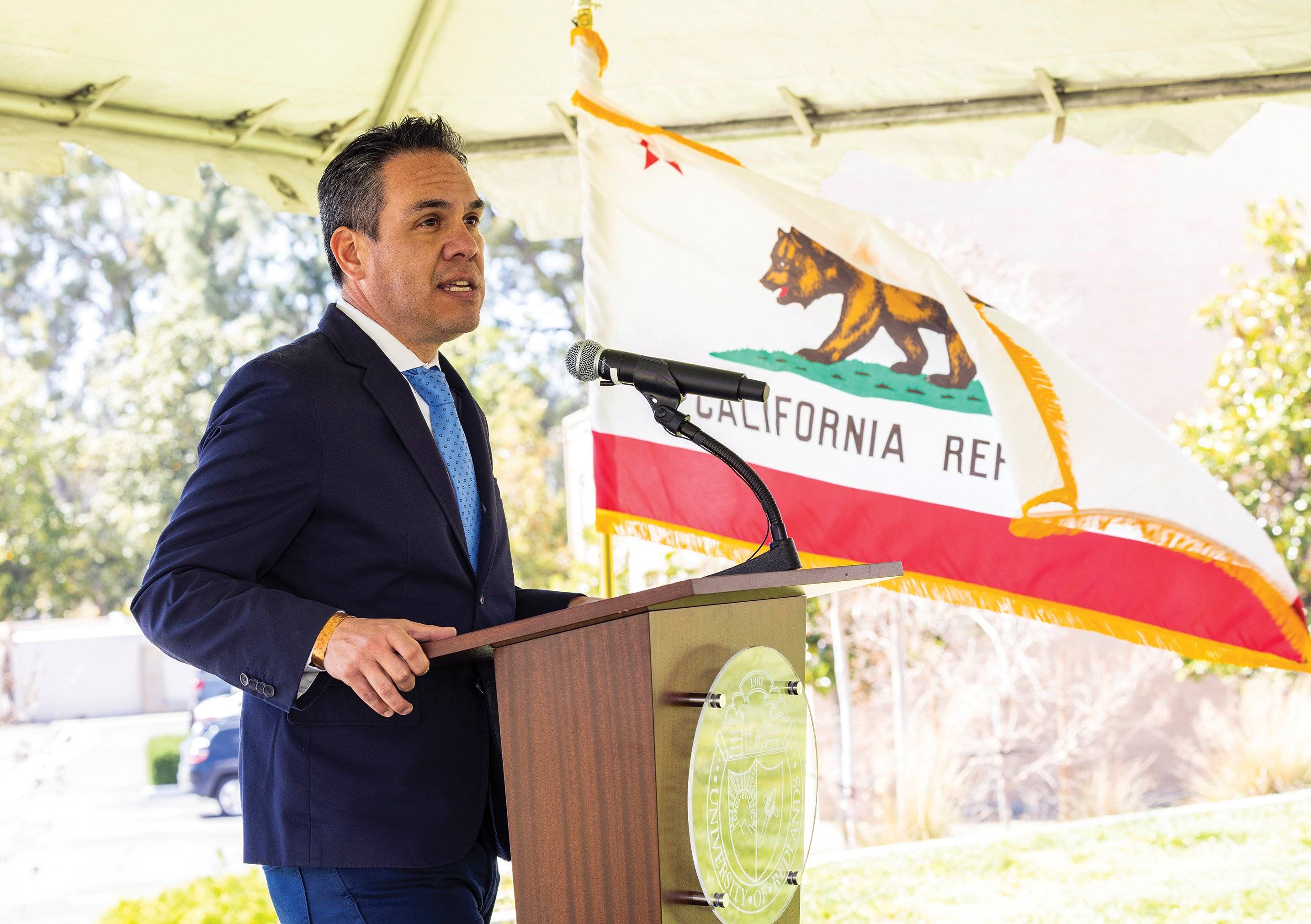 a person standing at a podium with a microphone