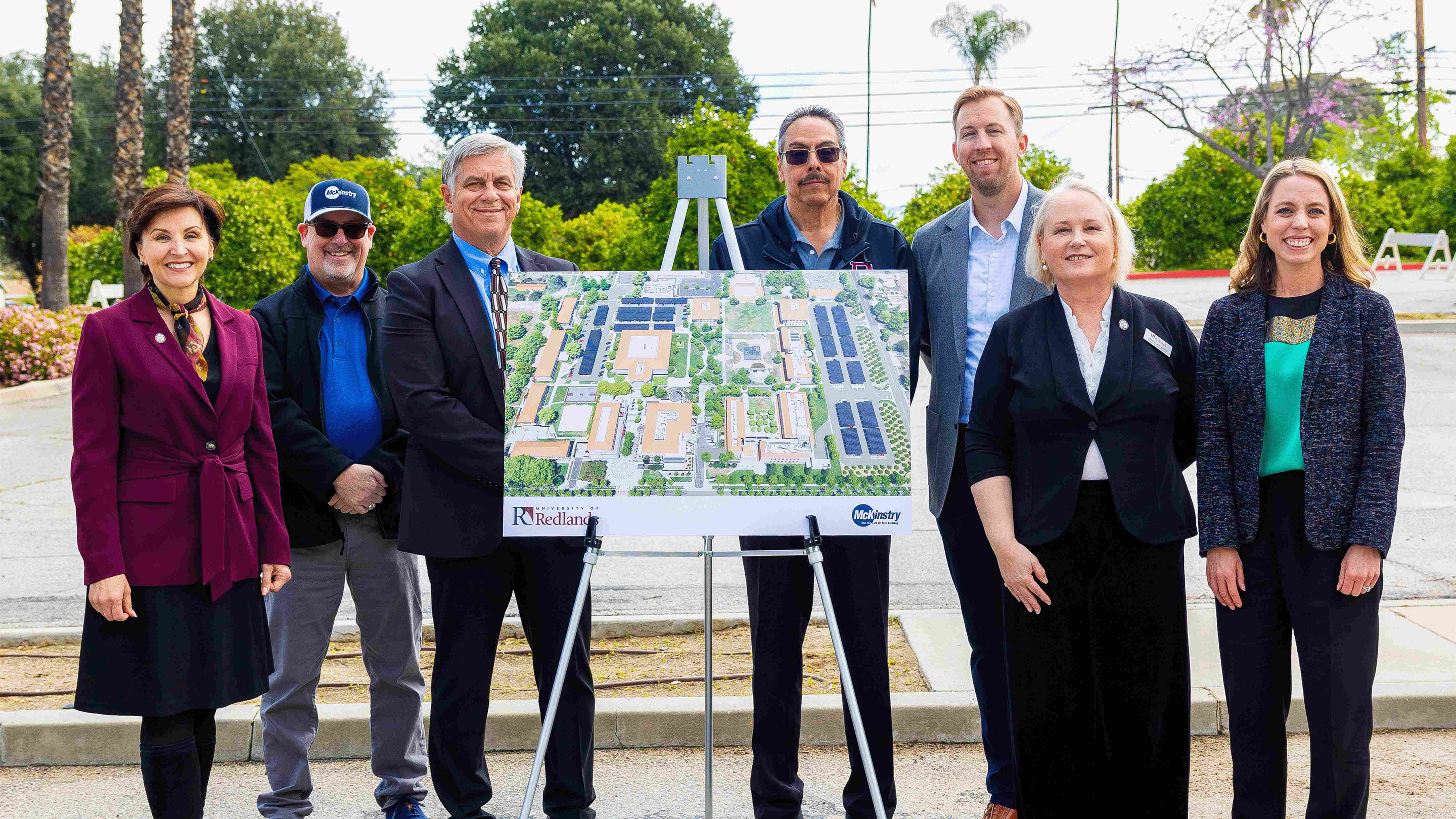 a group of people standing next to a map
