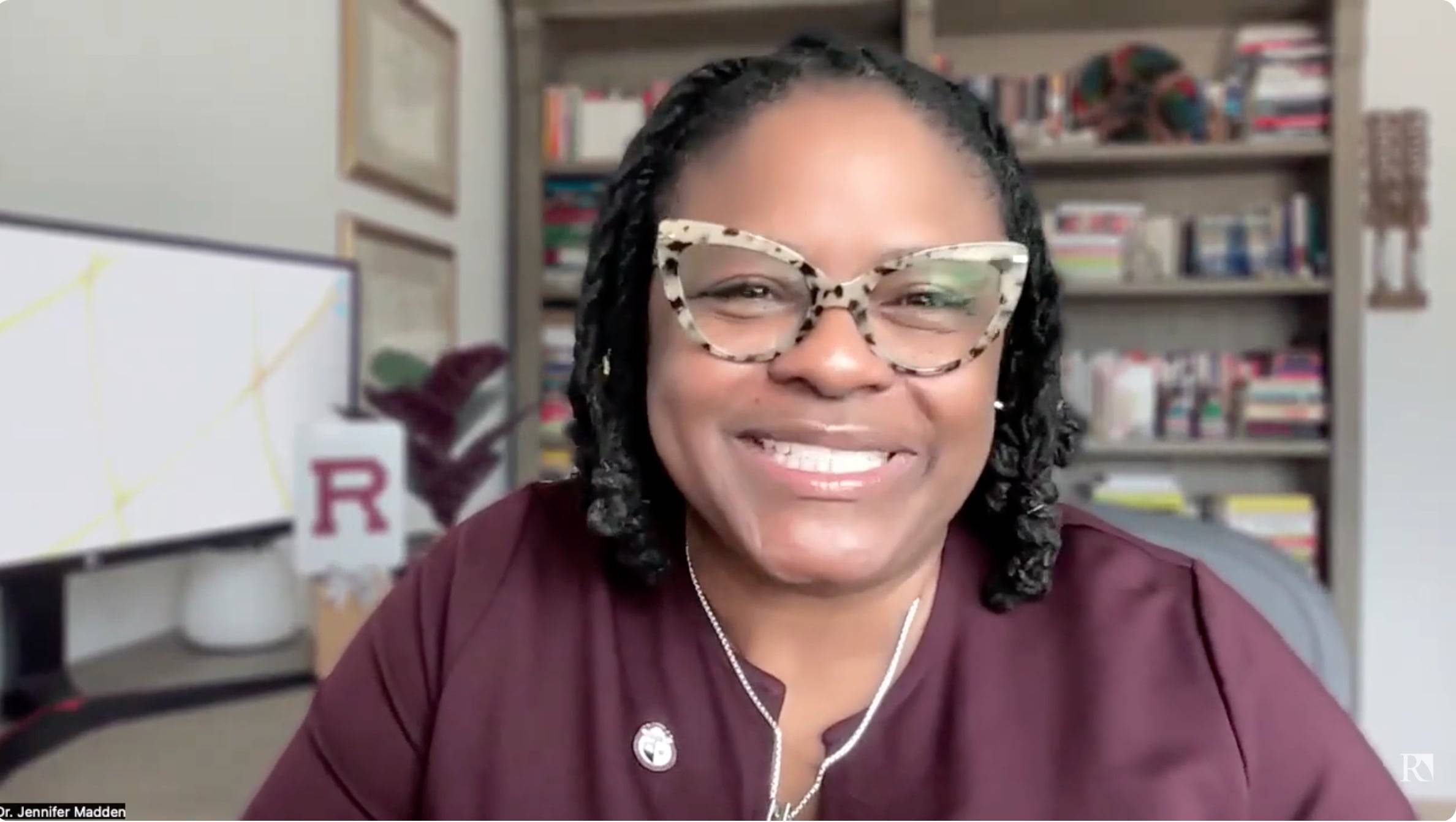 a person wearing glasses smiling