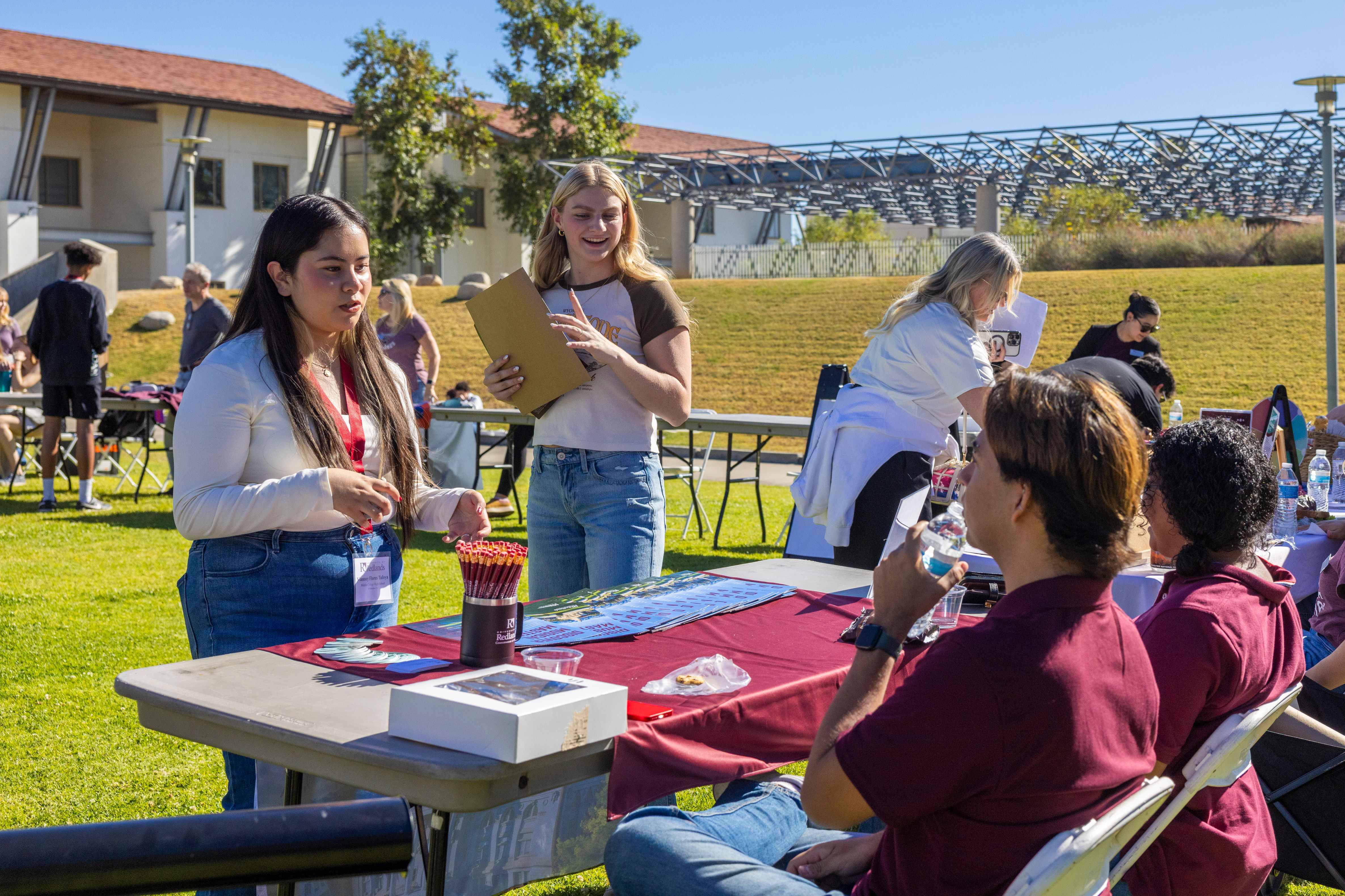 a group of people outside at a table
