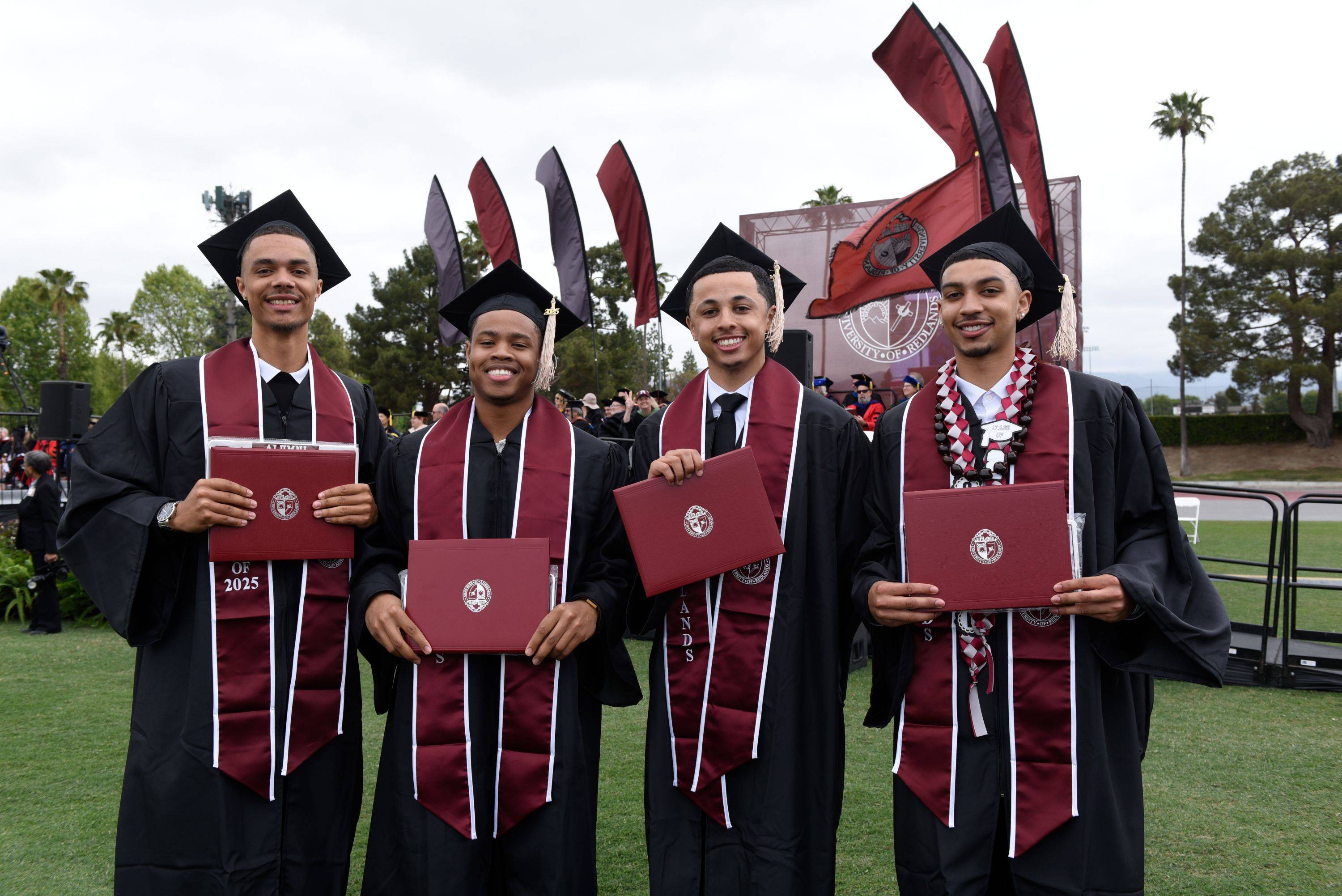 a group of men in graduation gowns and caps