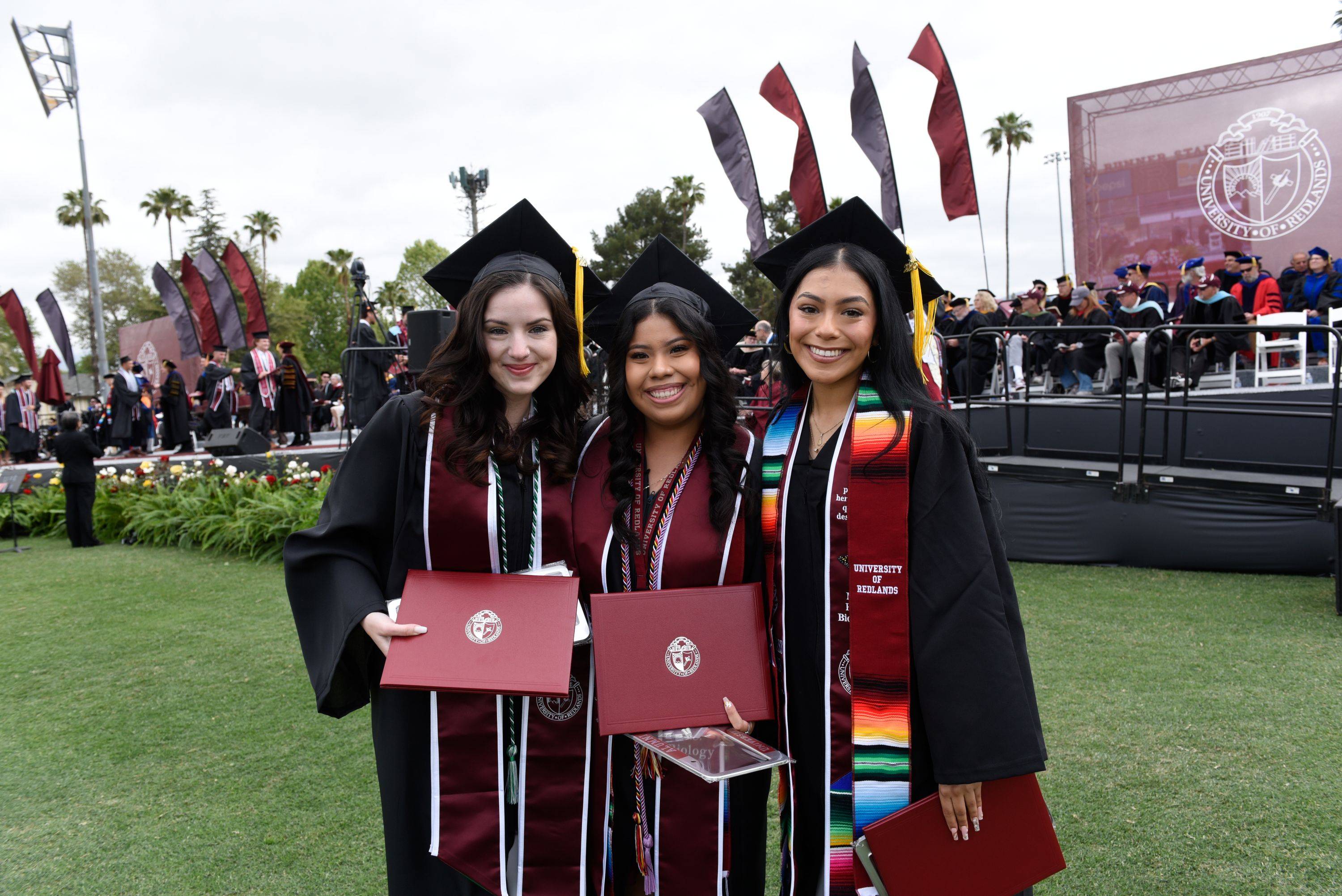 a group of women in graduation gowns and caps