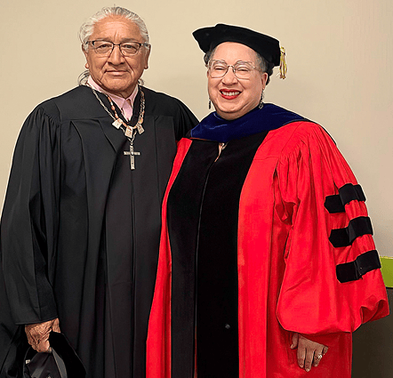a person and person wearing graduation gowns