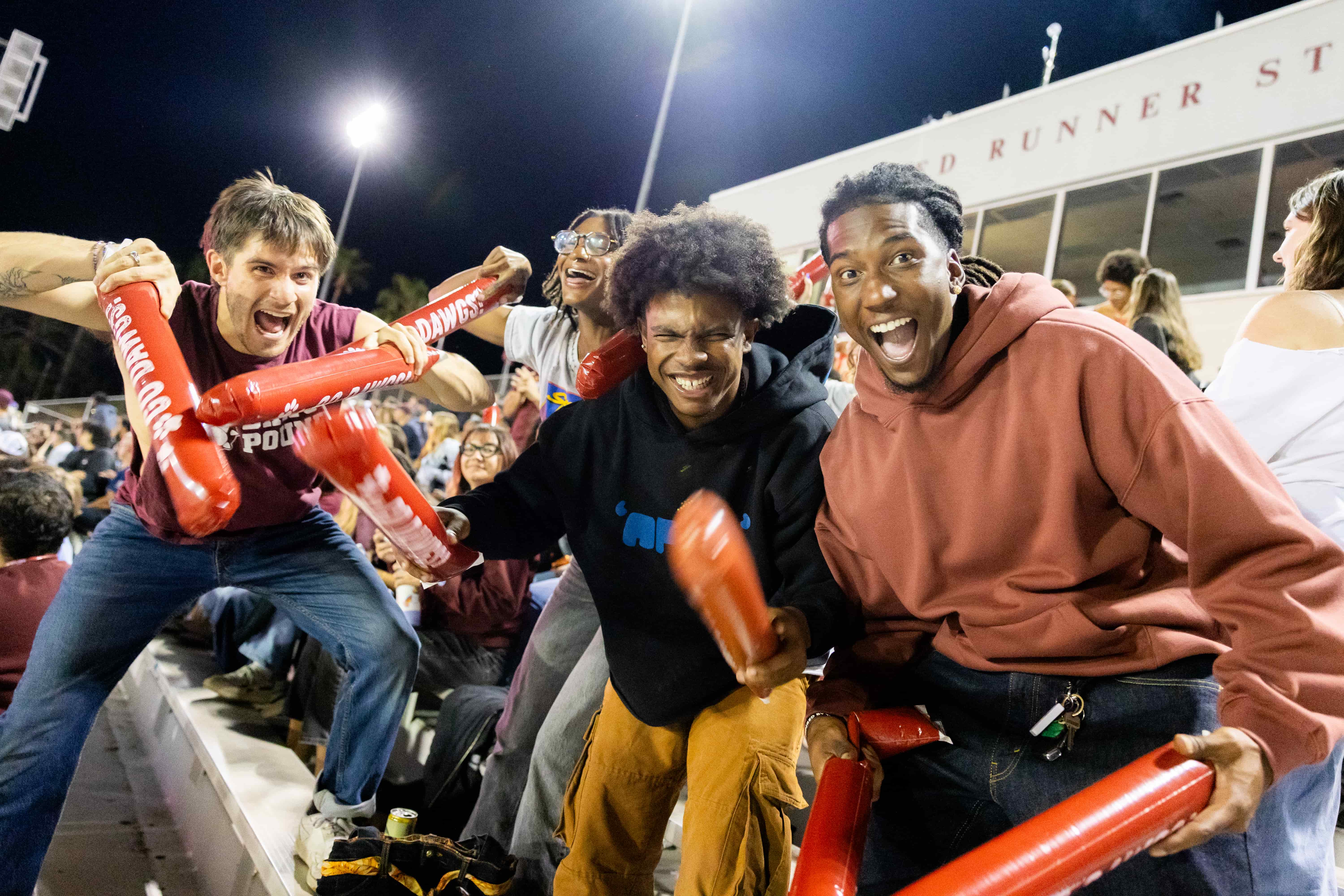 a group of people holding red objects