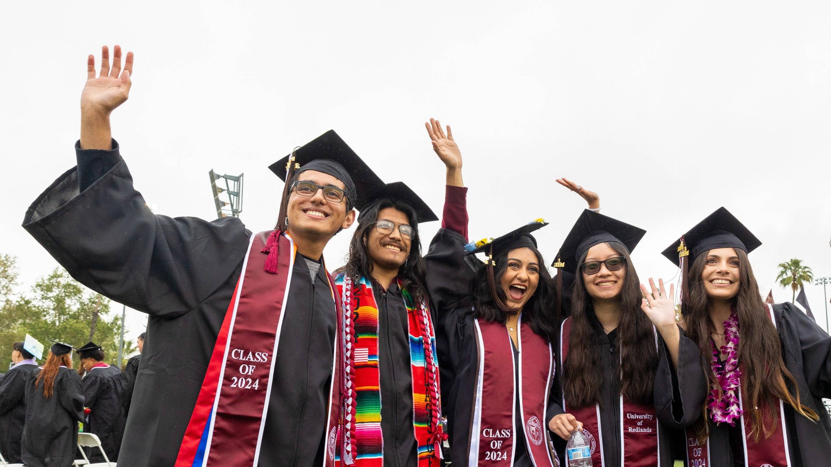 a group of people in graduation gowns and caps