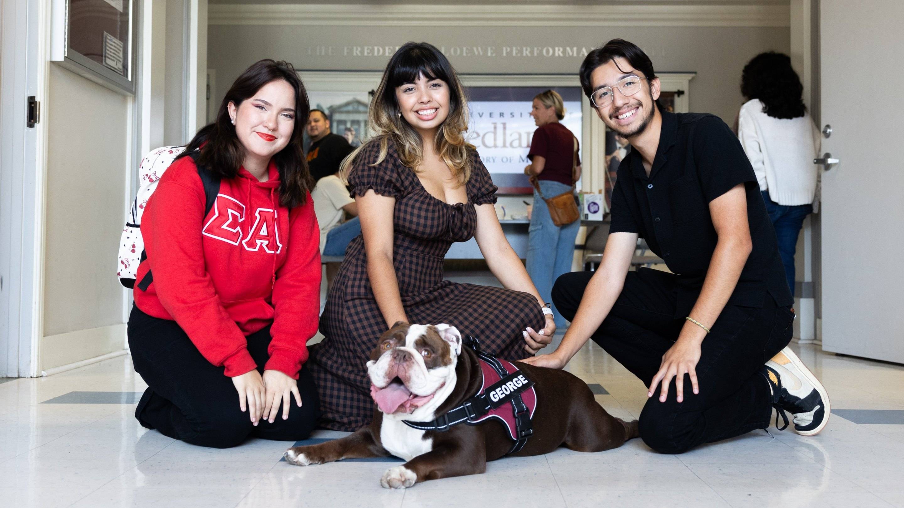 a group of people posing with a dog