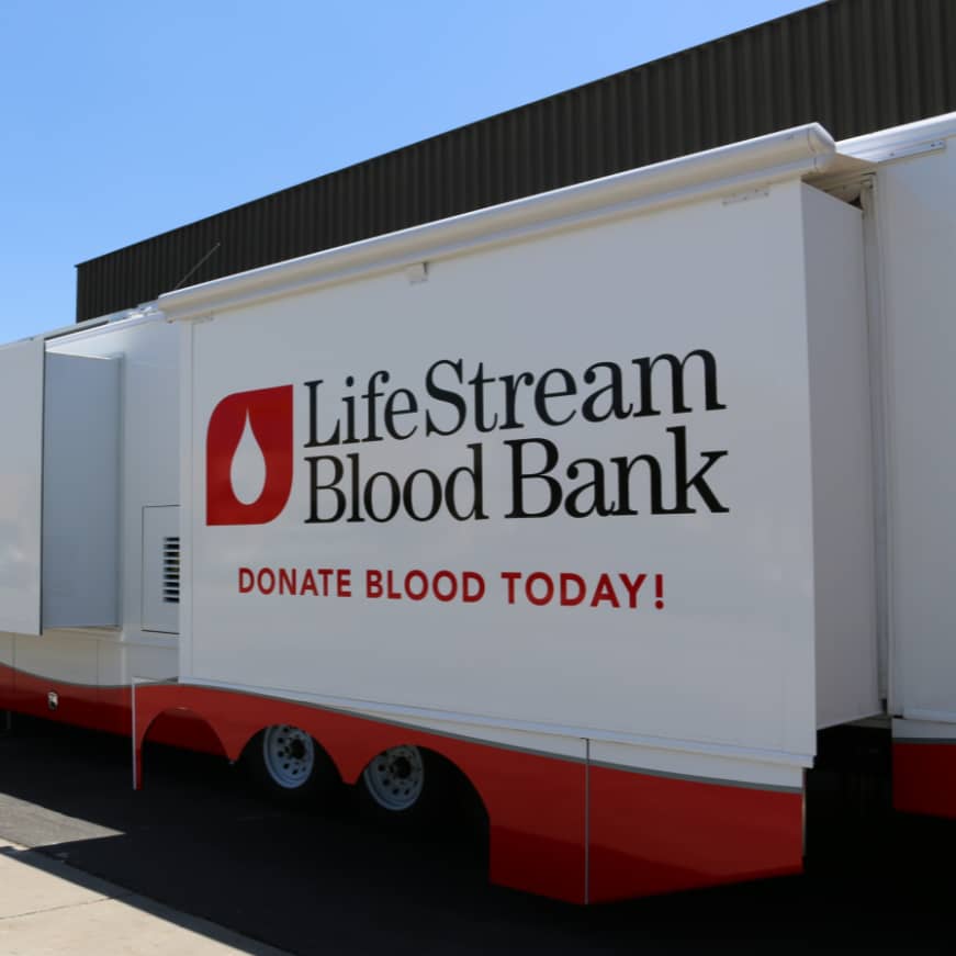 a white trailer with red trim