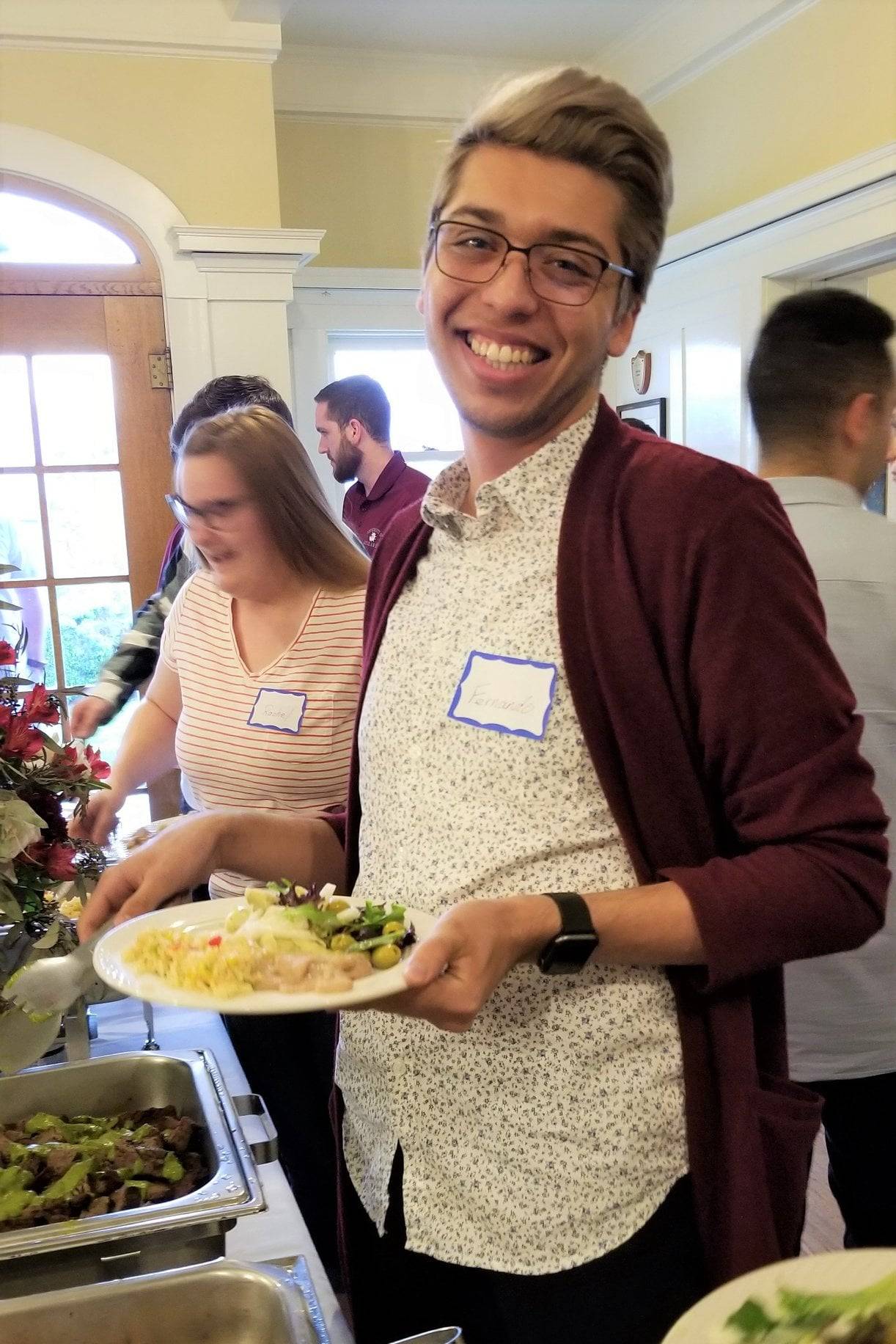 a person holding a plate of food