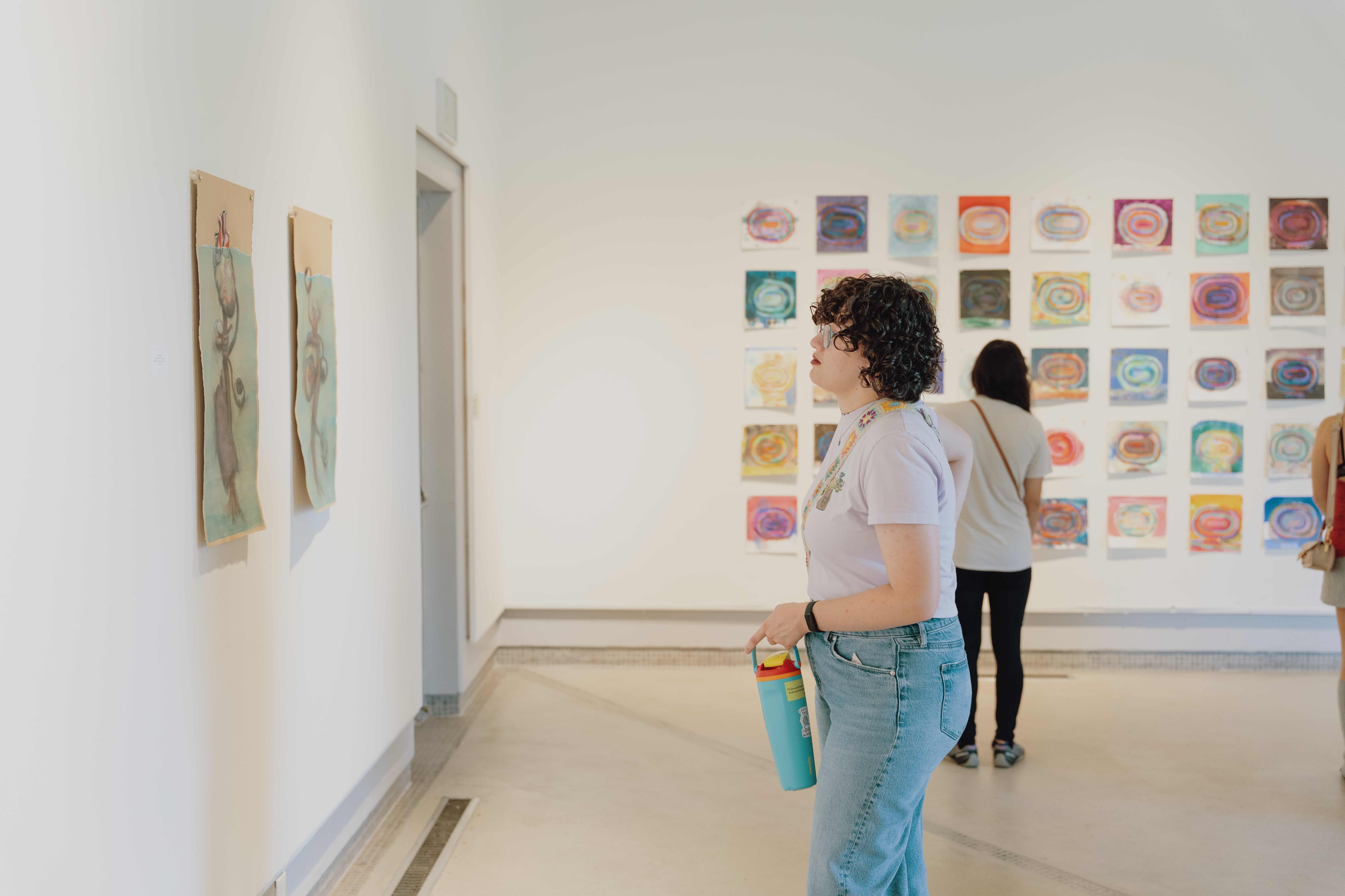 a person looking at art on the wall