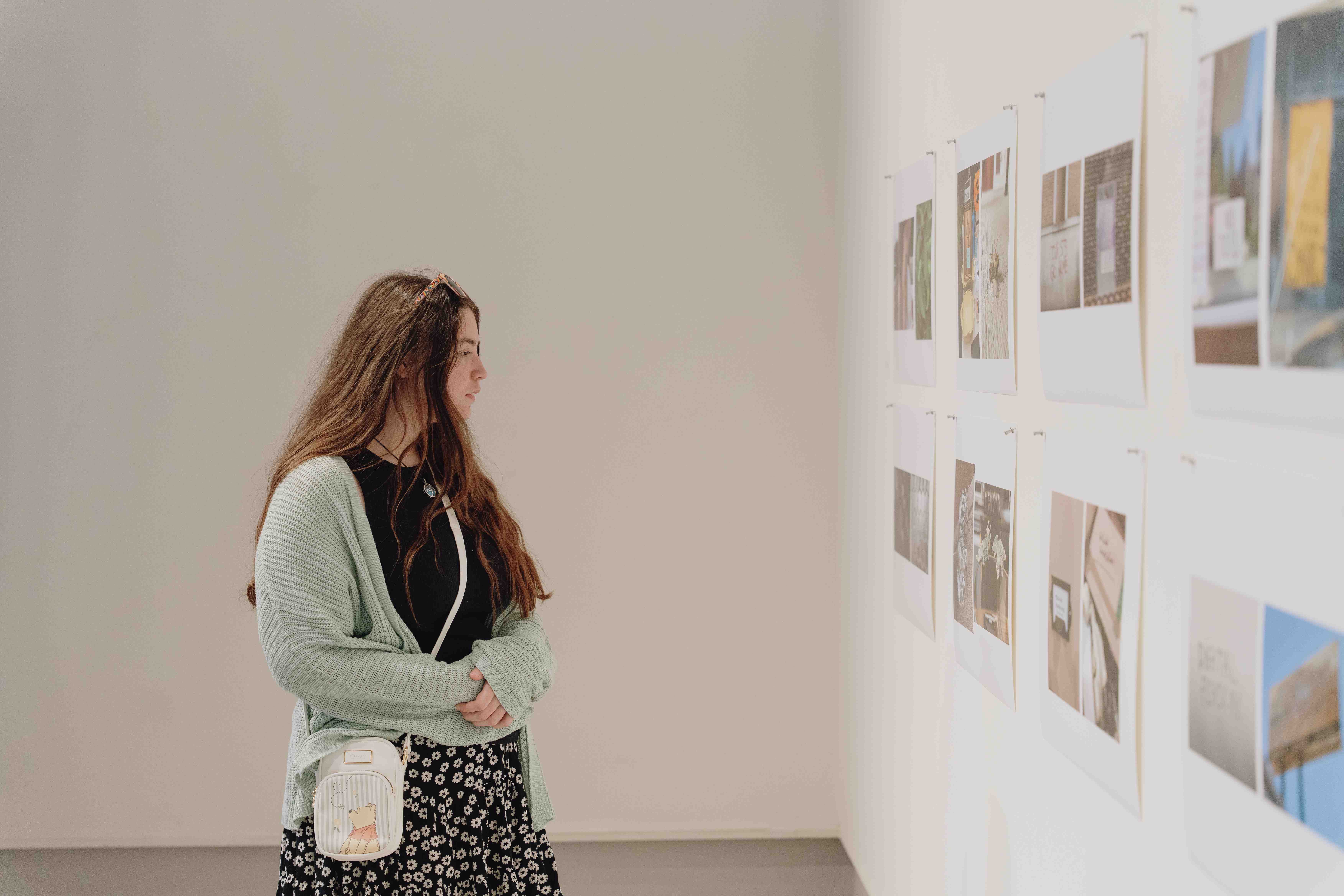 a person looking at pictures on a wall