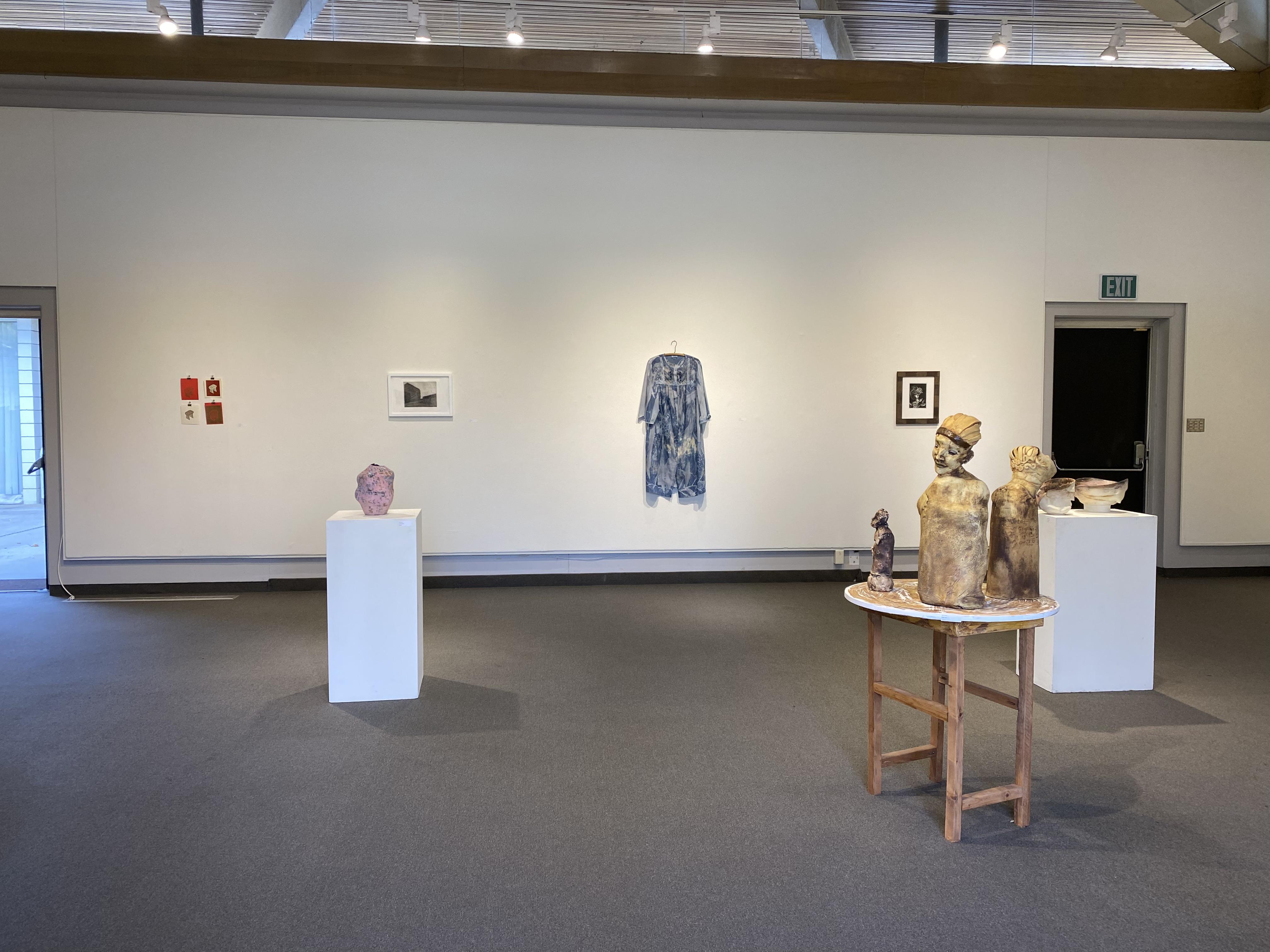 a room with a few sculptures on display