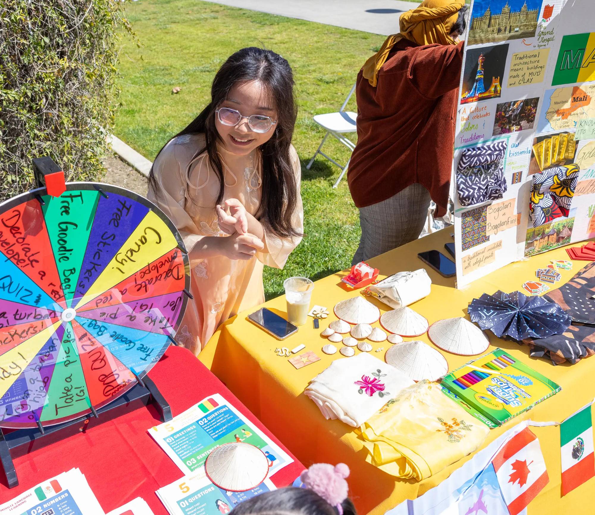 a person standing at a table with a wheel and other objects on it