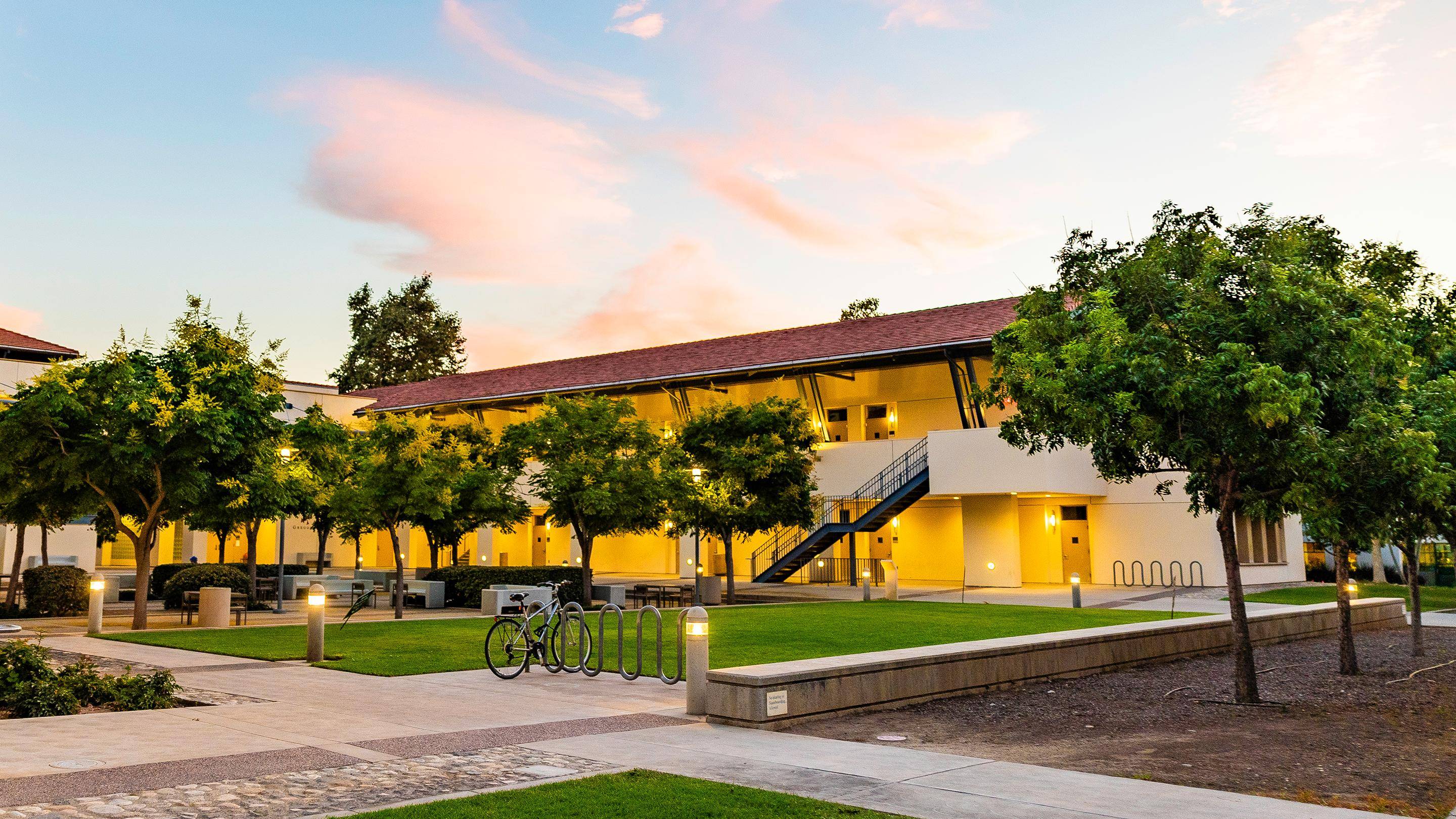a building with trees and a bike rack