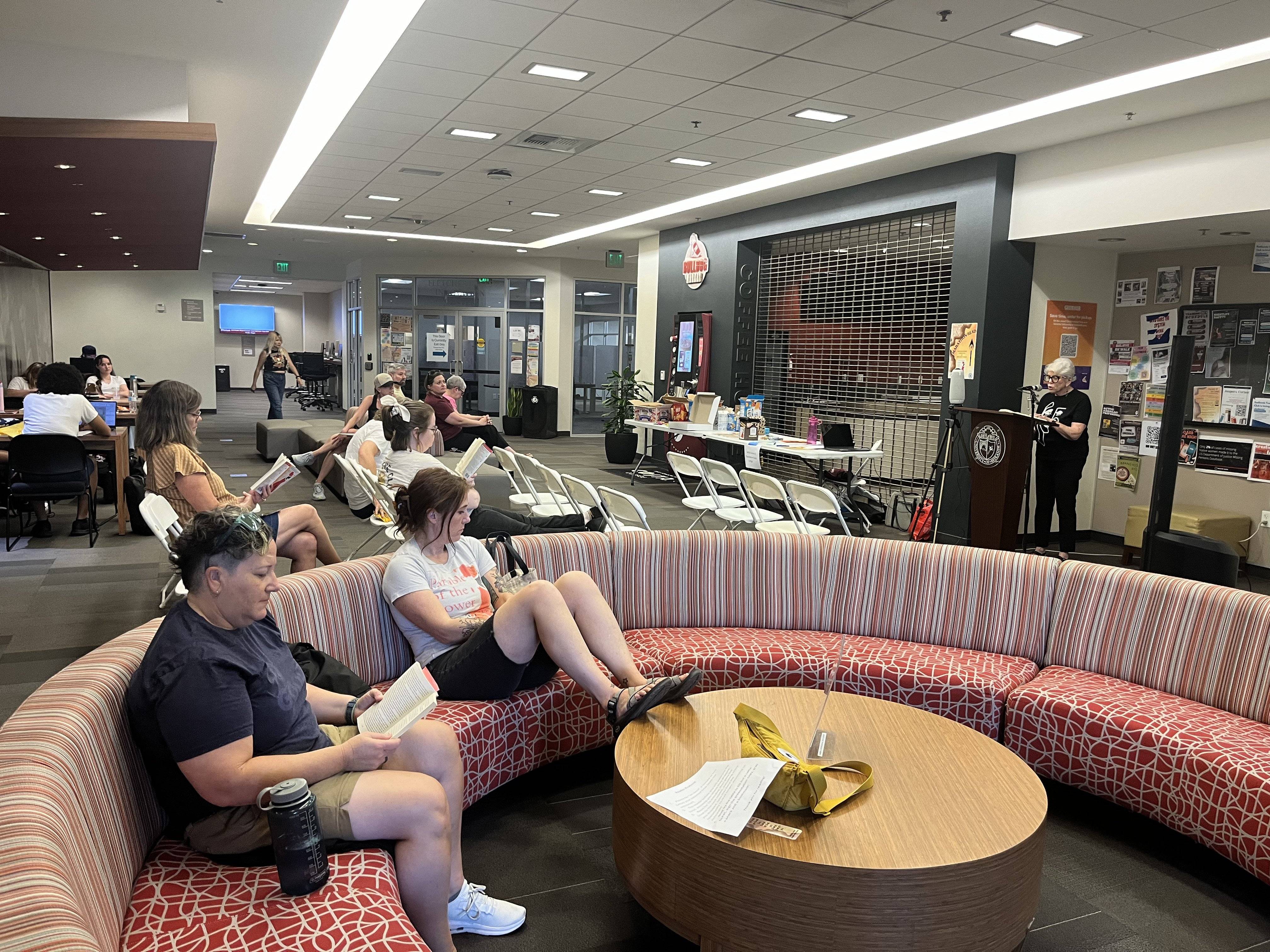 a group of people sitting on a round red and white couches