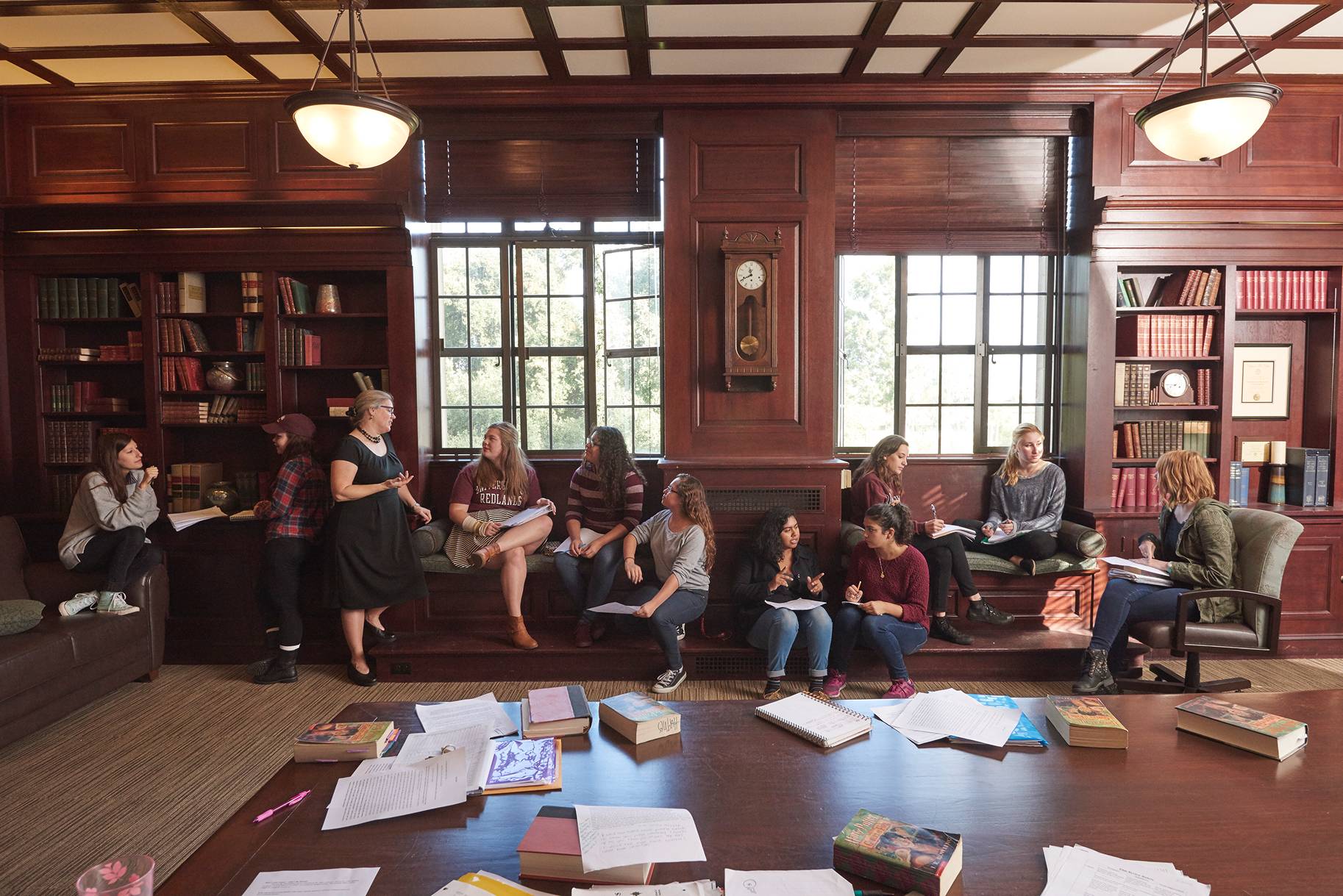 a group of people sitting on a bench in a library