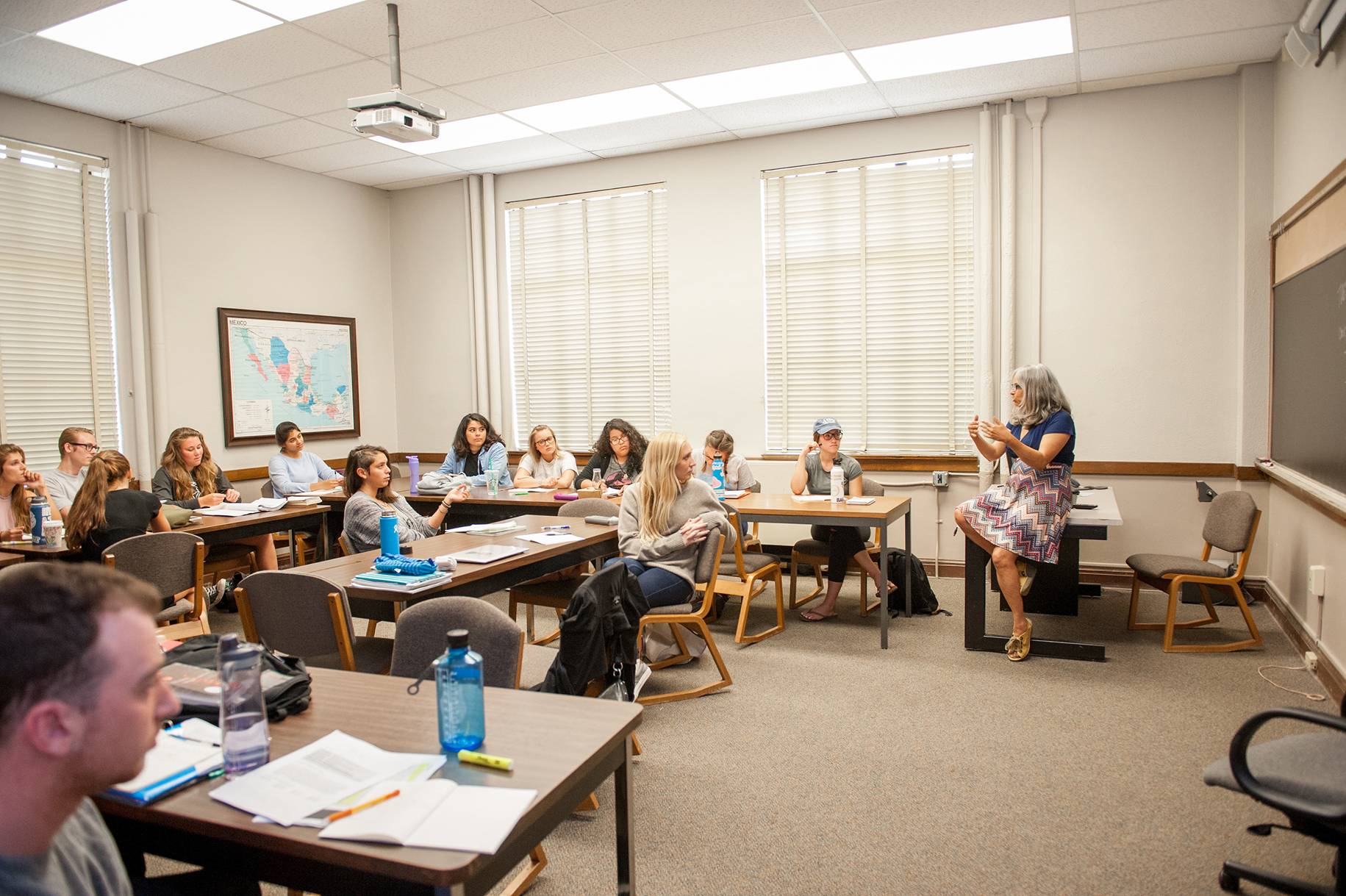 a group of people sitting in a classroom