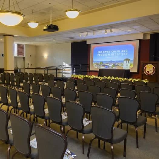 a room with chairs and a projector screen