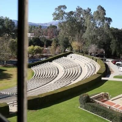 an outdoor theater with grass and trees