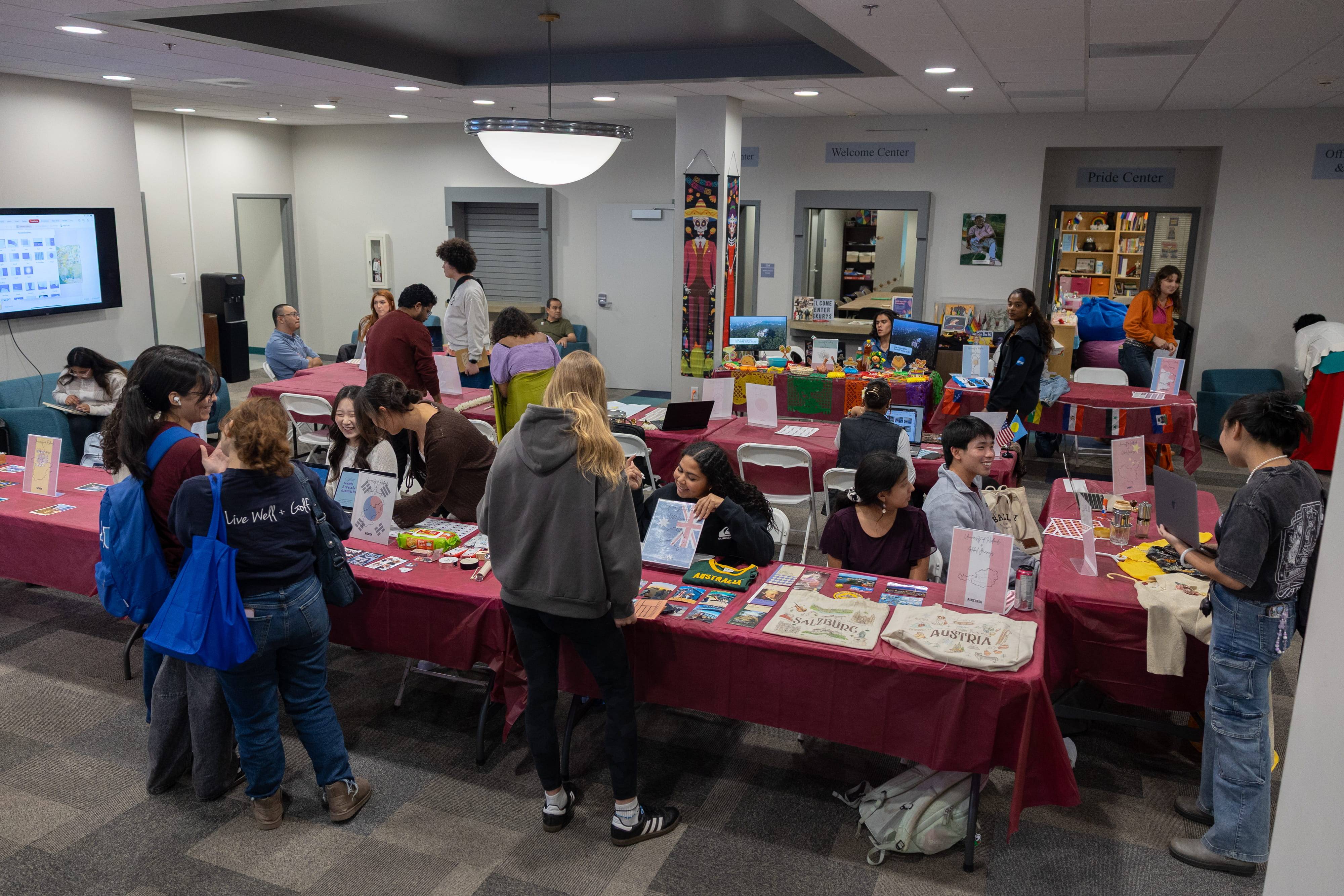a group of people in a room with tables with books