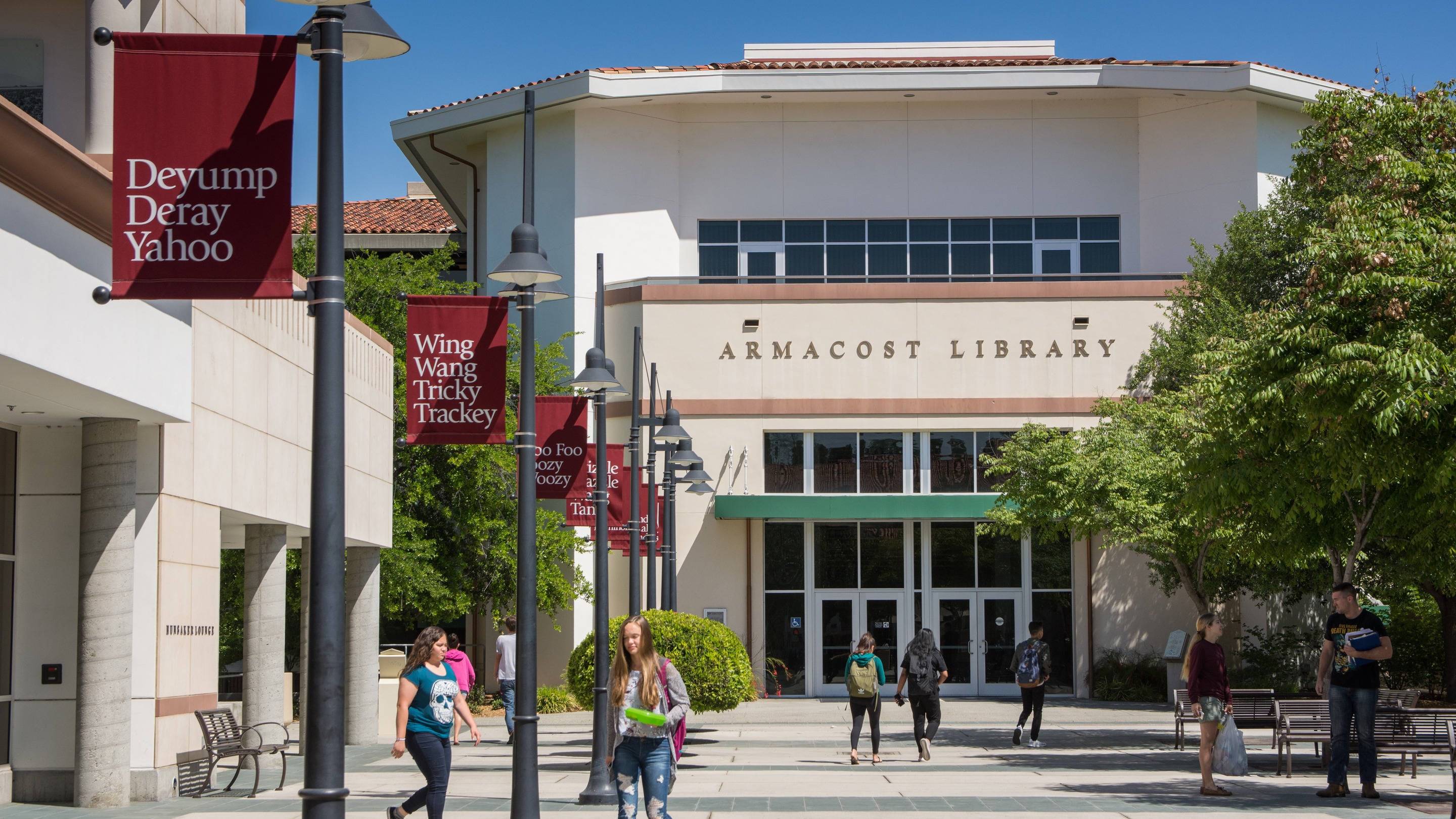 a group of people walking in front of a library