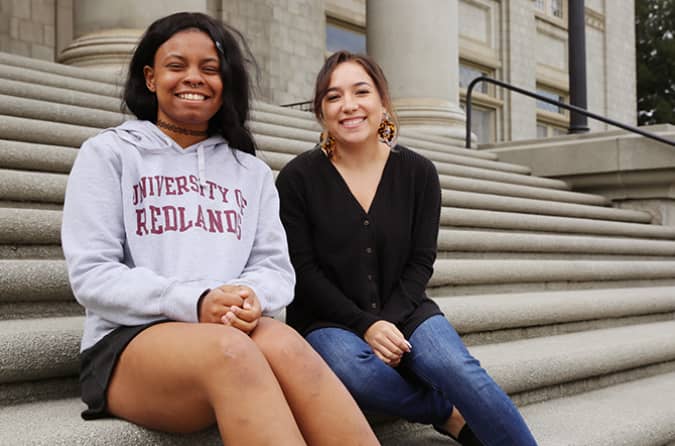 two women sitting on steps