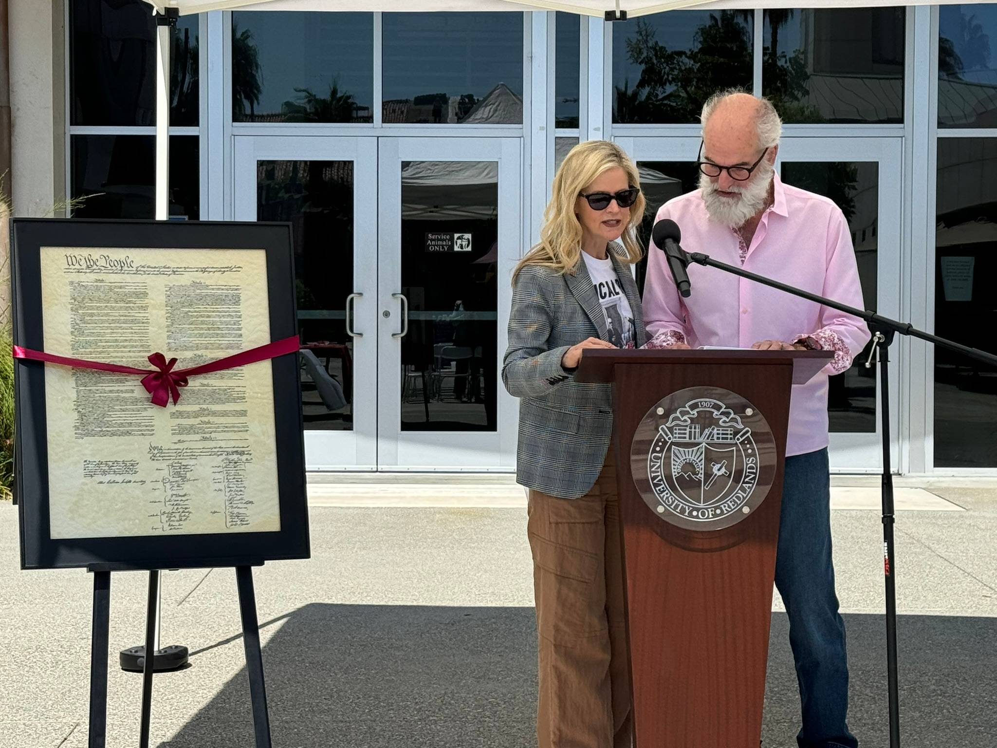 Two faculty members standing at a podium