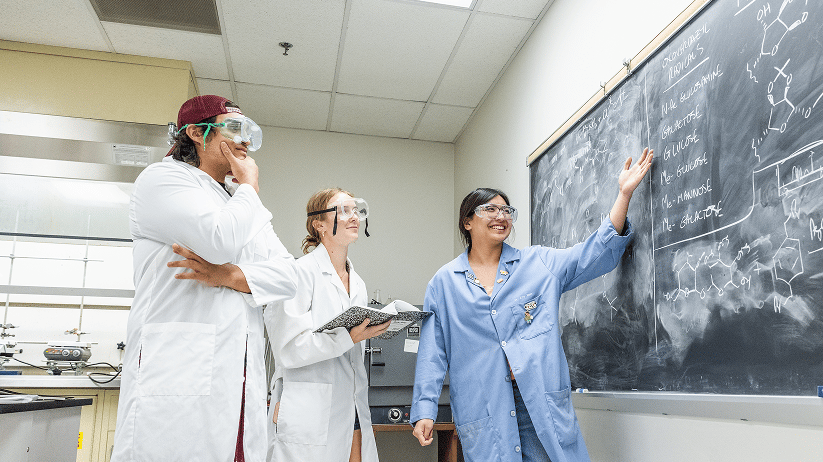 a group of people wearing lab coats and goggles