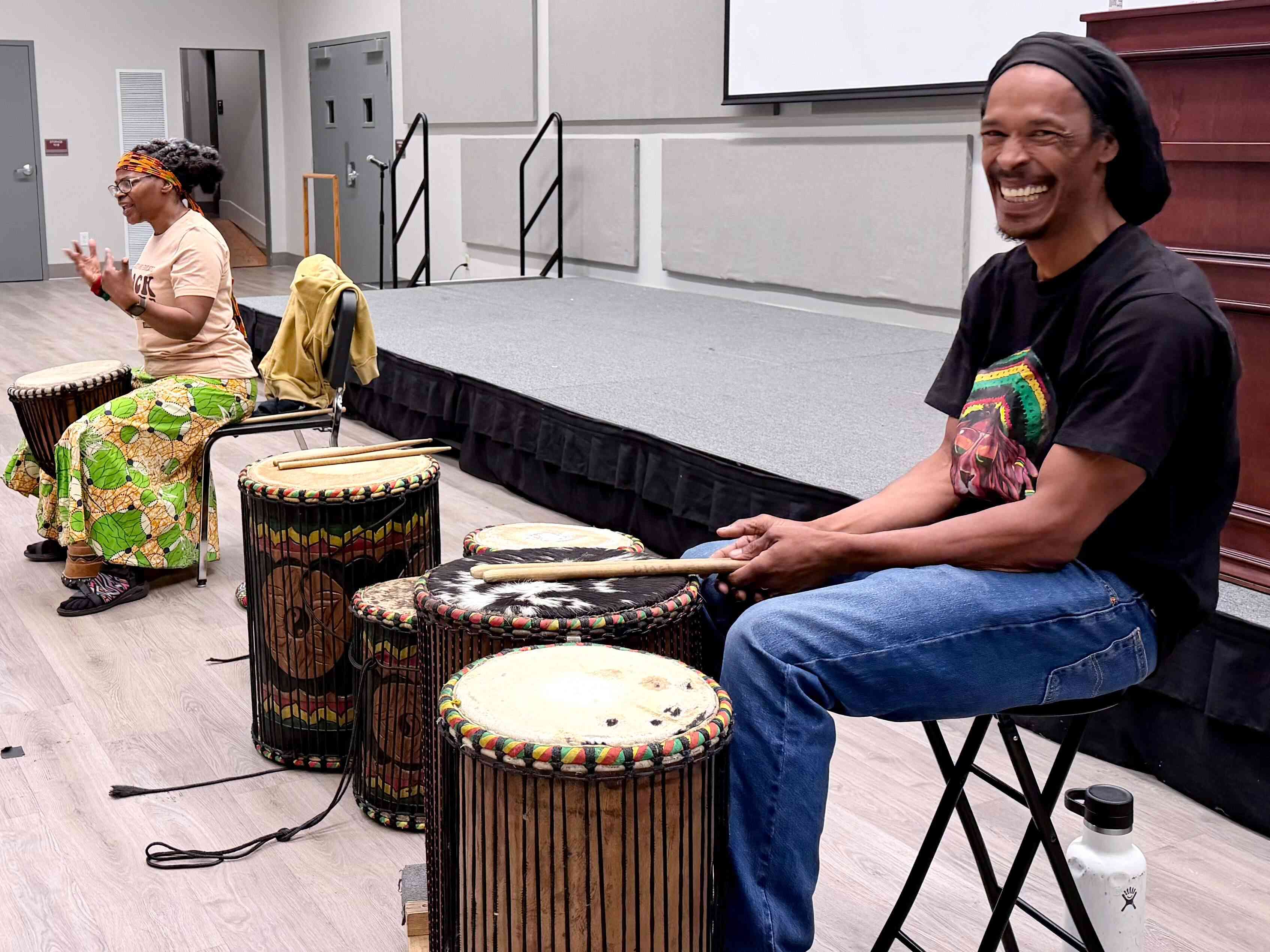 a person sitting on a chair with drums