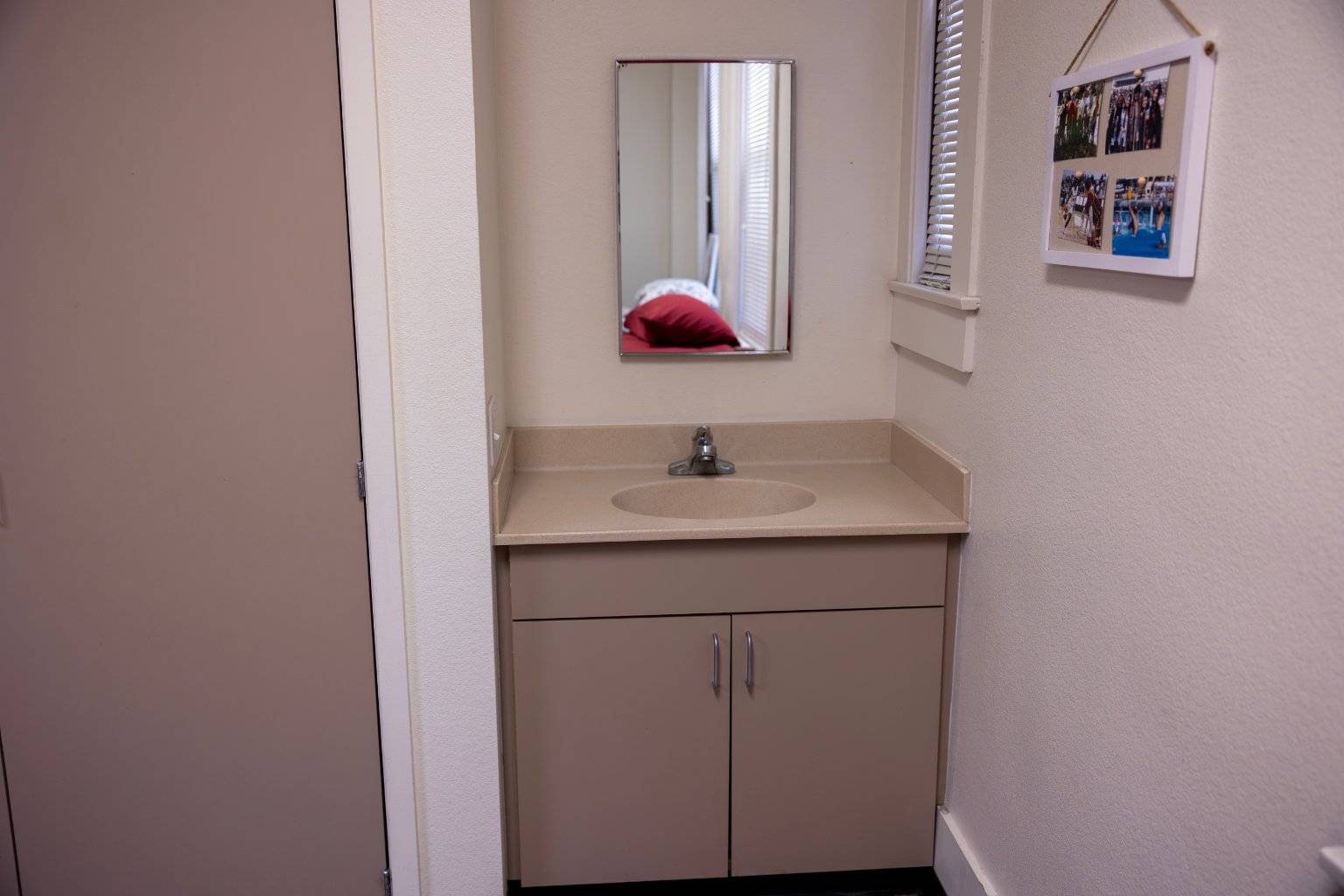 a bathroom sink with a mirror above it
