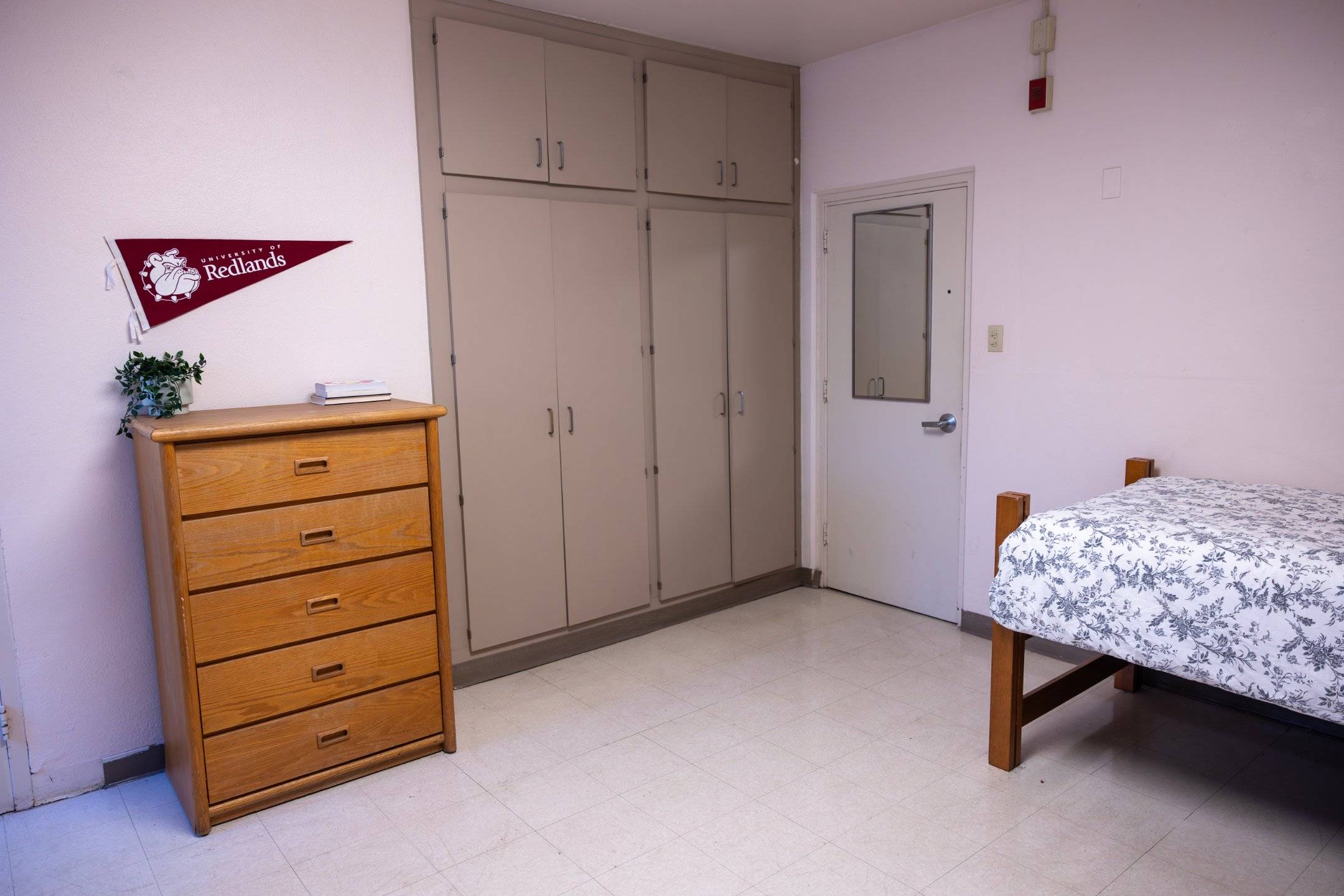 a room with a bed and dresser