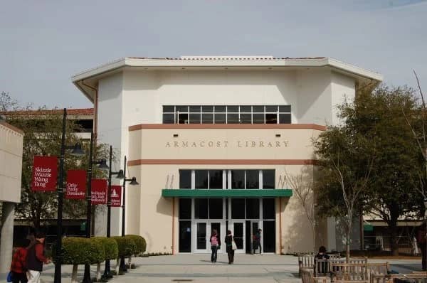 a library building with people walking in front of it