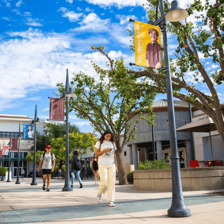 a group of people walking on a sidewalk
