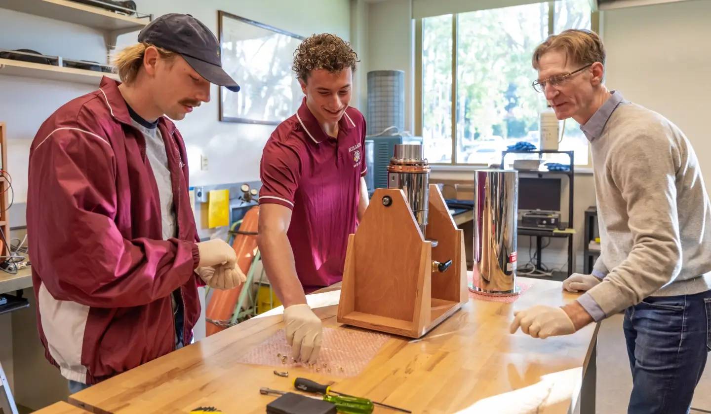 a group of men in uniform looking at a device