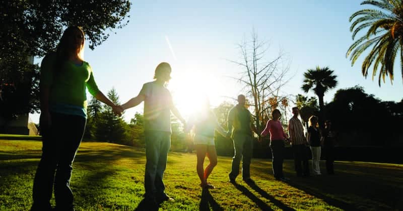 a group of people holding hands