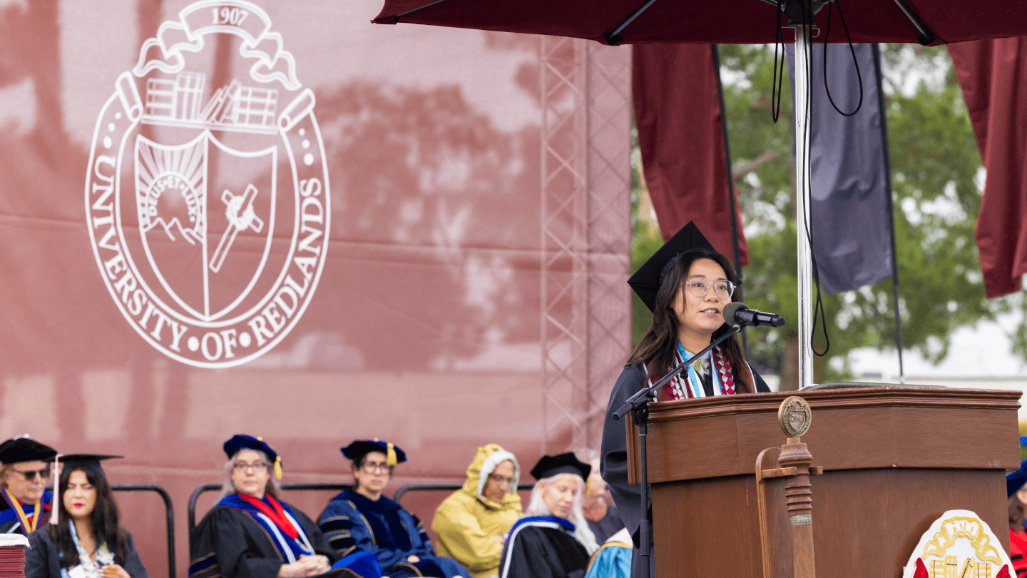 student commencement speaker standing at podium