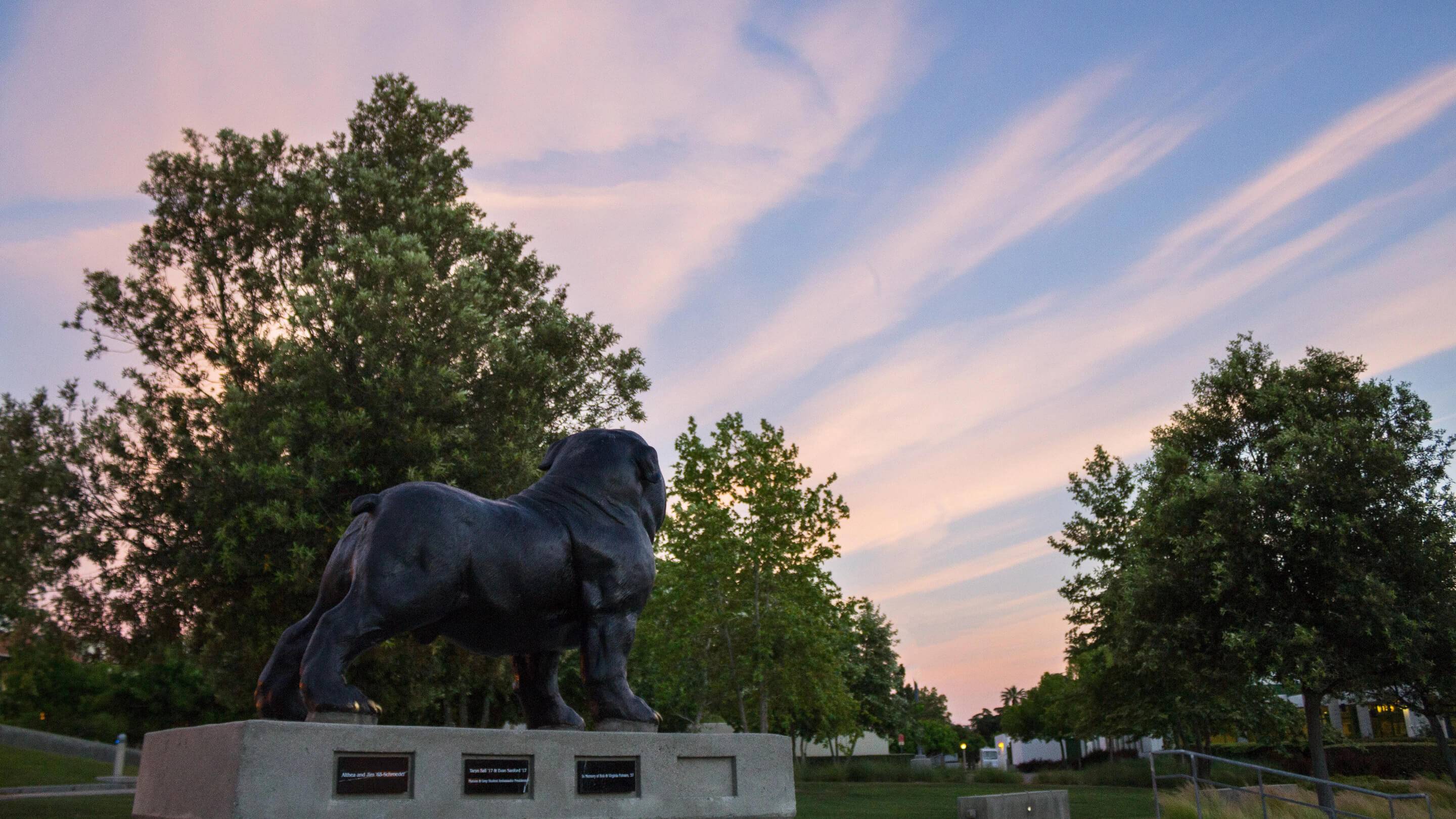 a statue of a dog in a park