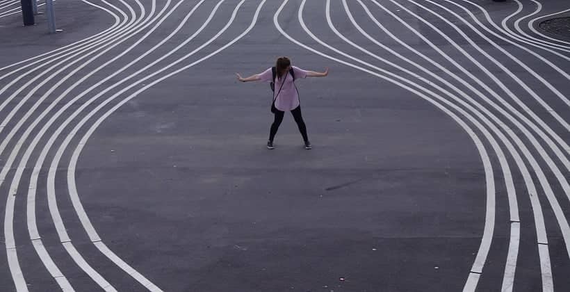 a person standing in a circle with her arms out