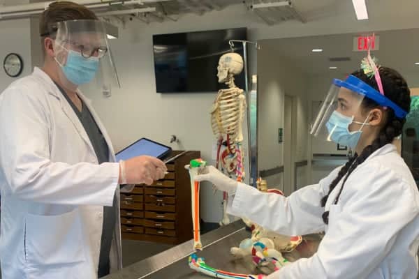 a couple of people wearing face masks and gloves