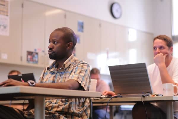 a person sitting at a desk with a laptop