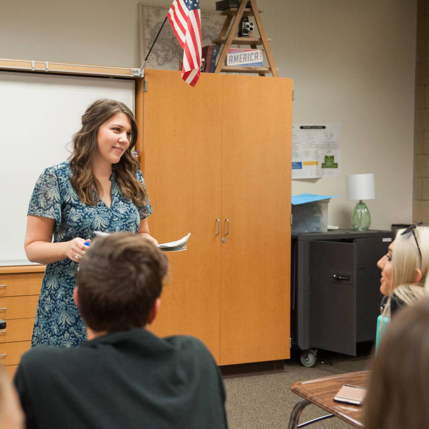 a person standing in front of a classroom