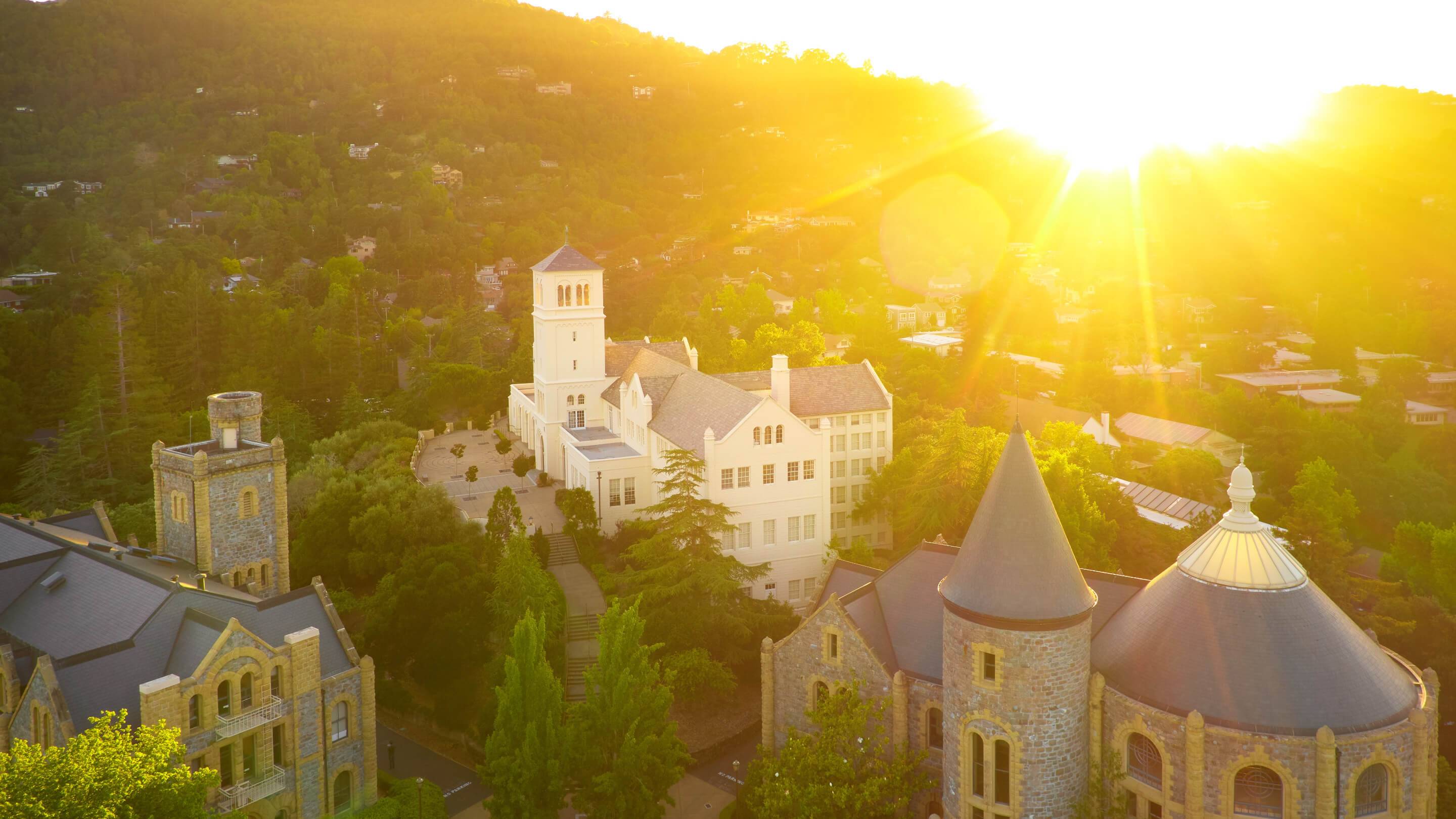 a building with a tower and trees in the background