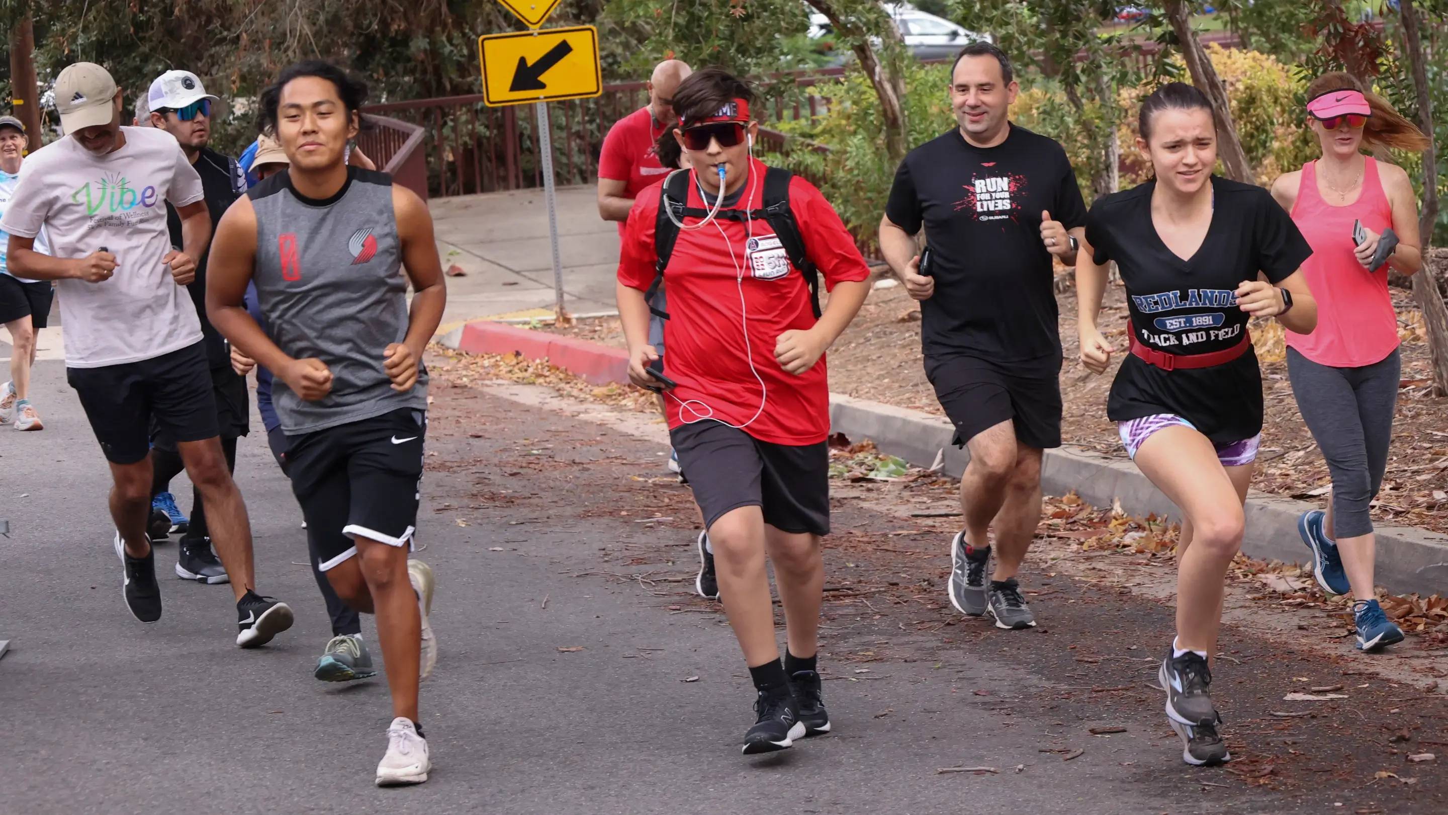a group of people running on a street