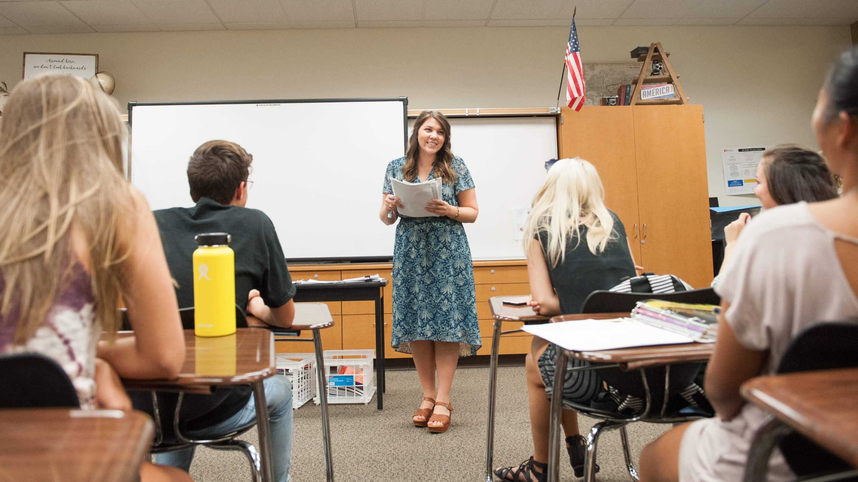 a person standing in front of a whiteboard
