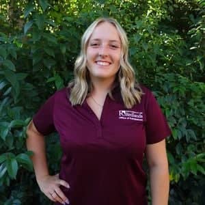 a person standing in front of a bush